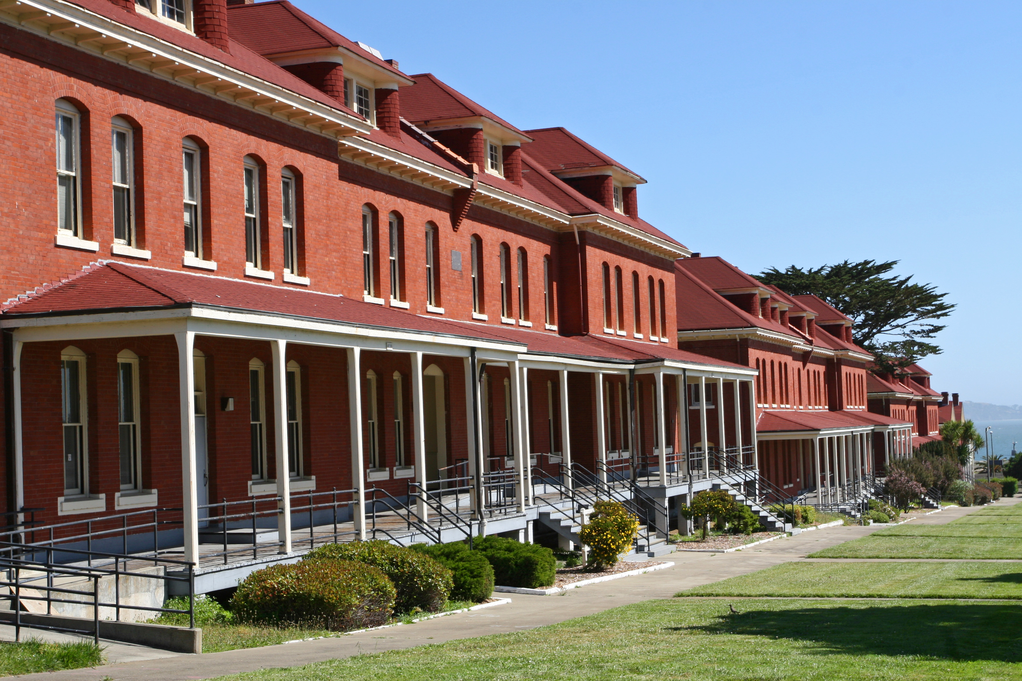 Row of red brick barracks with white-columned porches where infantry soldiers lived.
