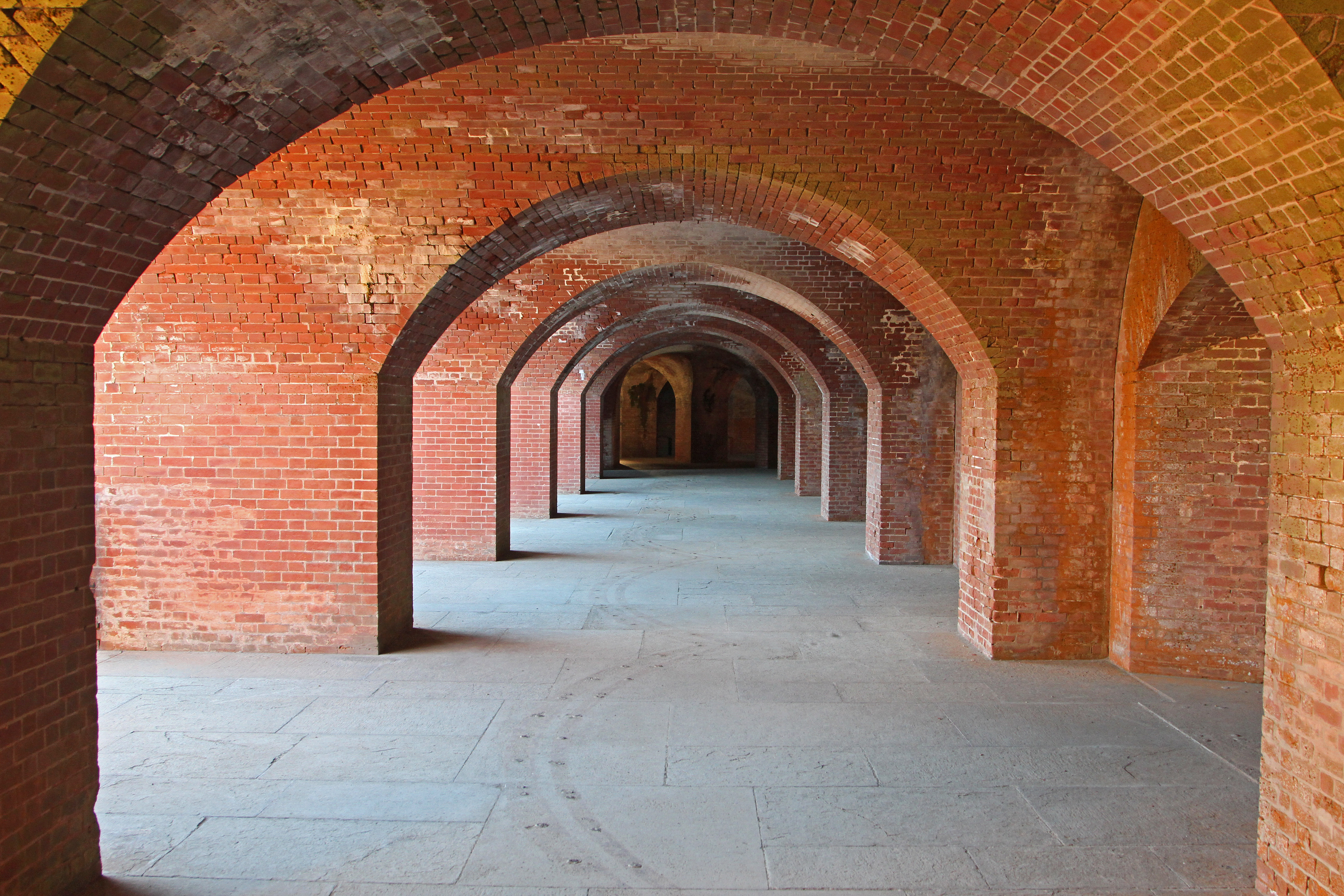 Arched red brick casemates extend into the distance at Fort Point.