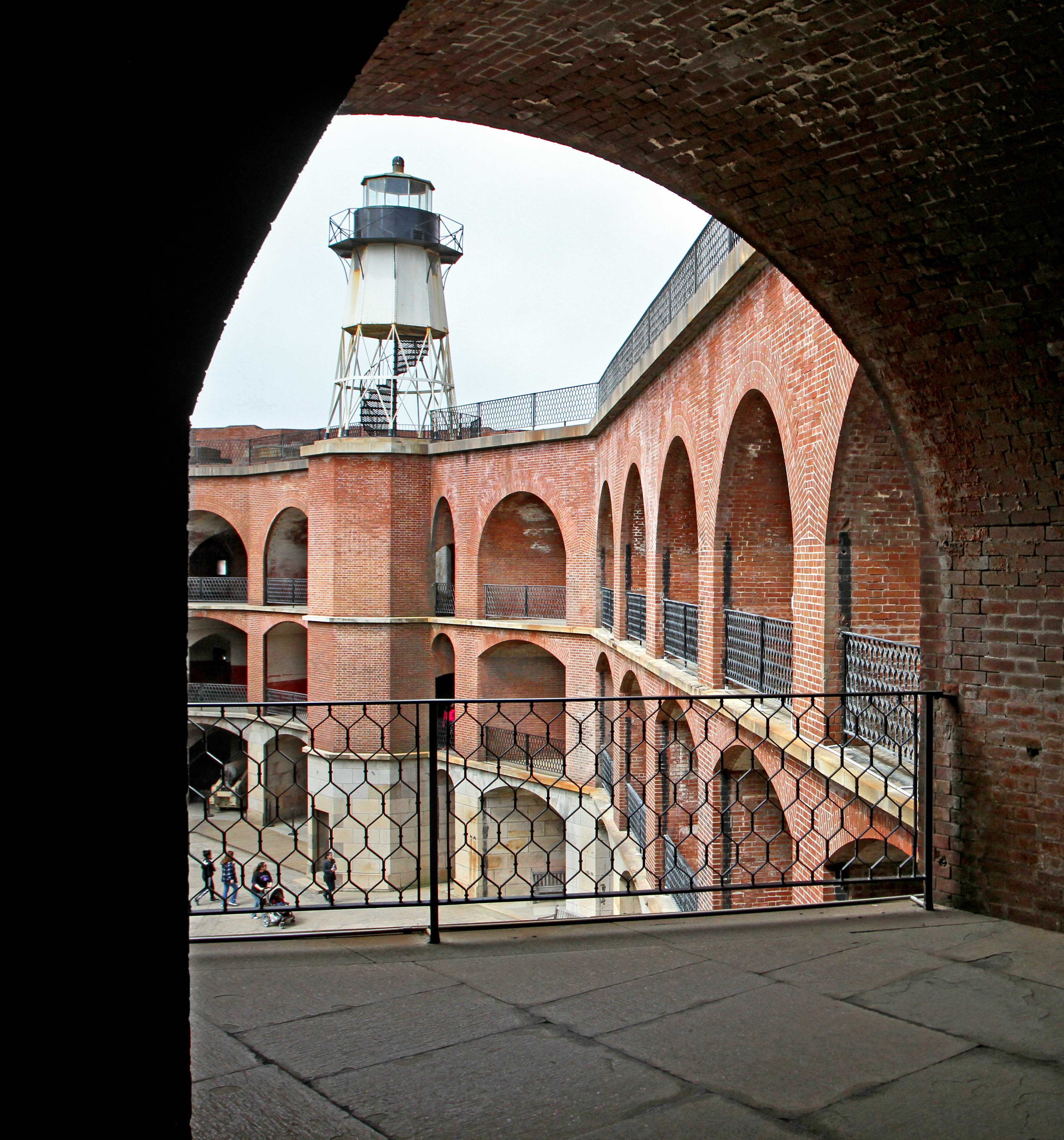 View of Fort Point lighthouse through red brick arches