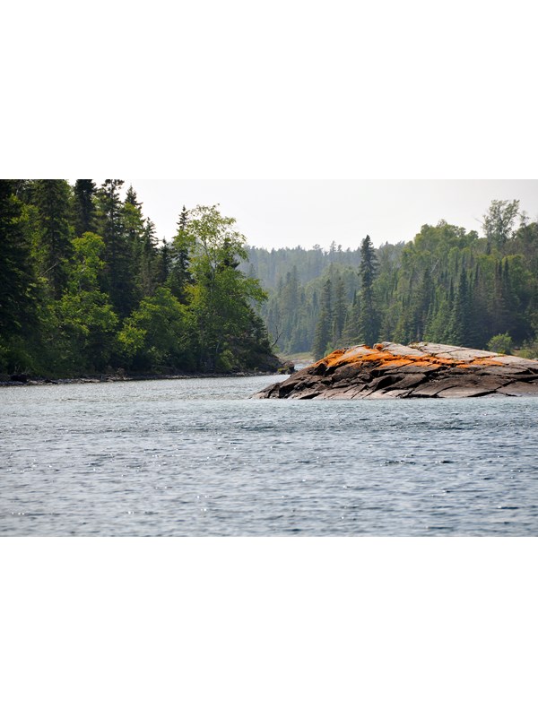 A lichen-covered rock marks the entrance to Chippewa Harbor.