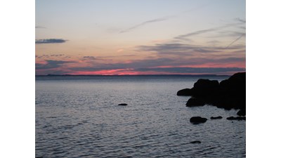 Colorful sunset over Lake Superior at Hugunnin Cove Campground