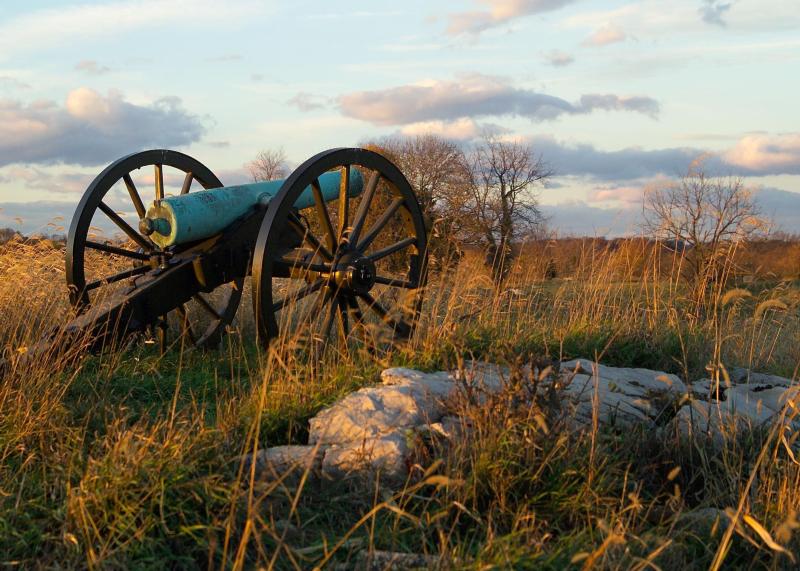 artillery piece sitting on a rock break