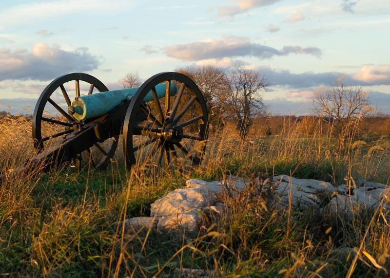 artillery piece sitting on a rock break