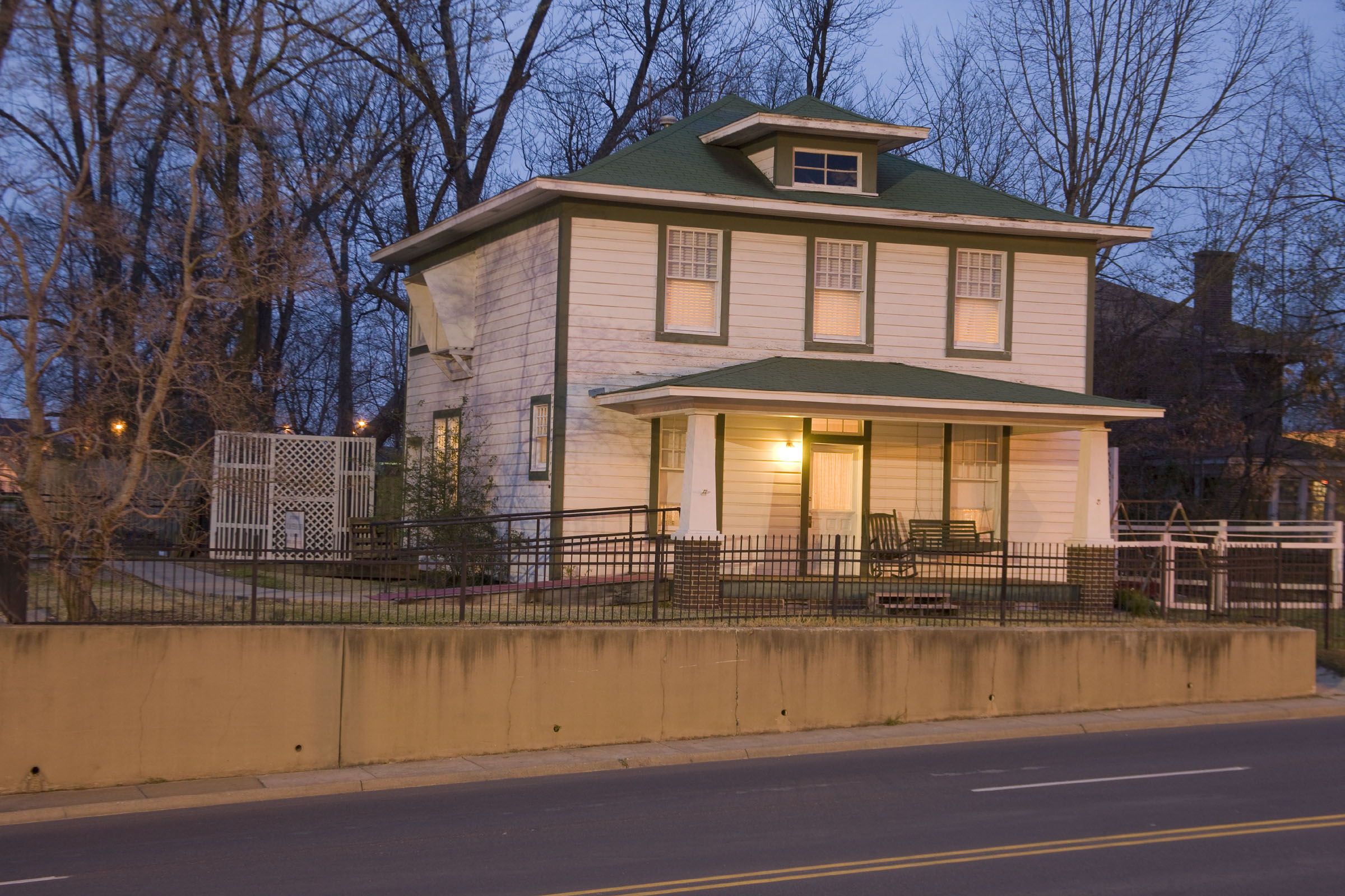 The birthplace home of President Bill Clinton illuminated at dusk.
