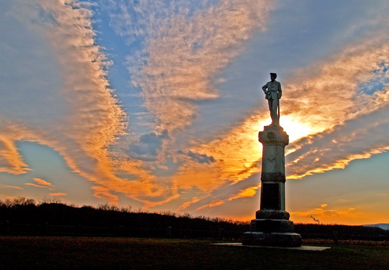14 New Jersey Regiment Monument The sun setting behind a monument.