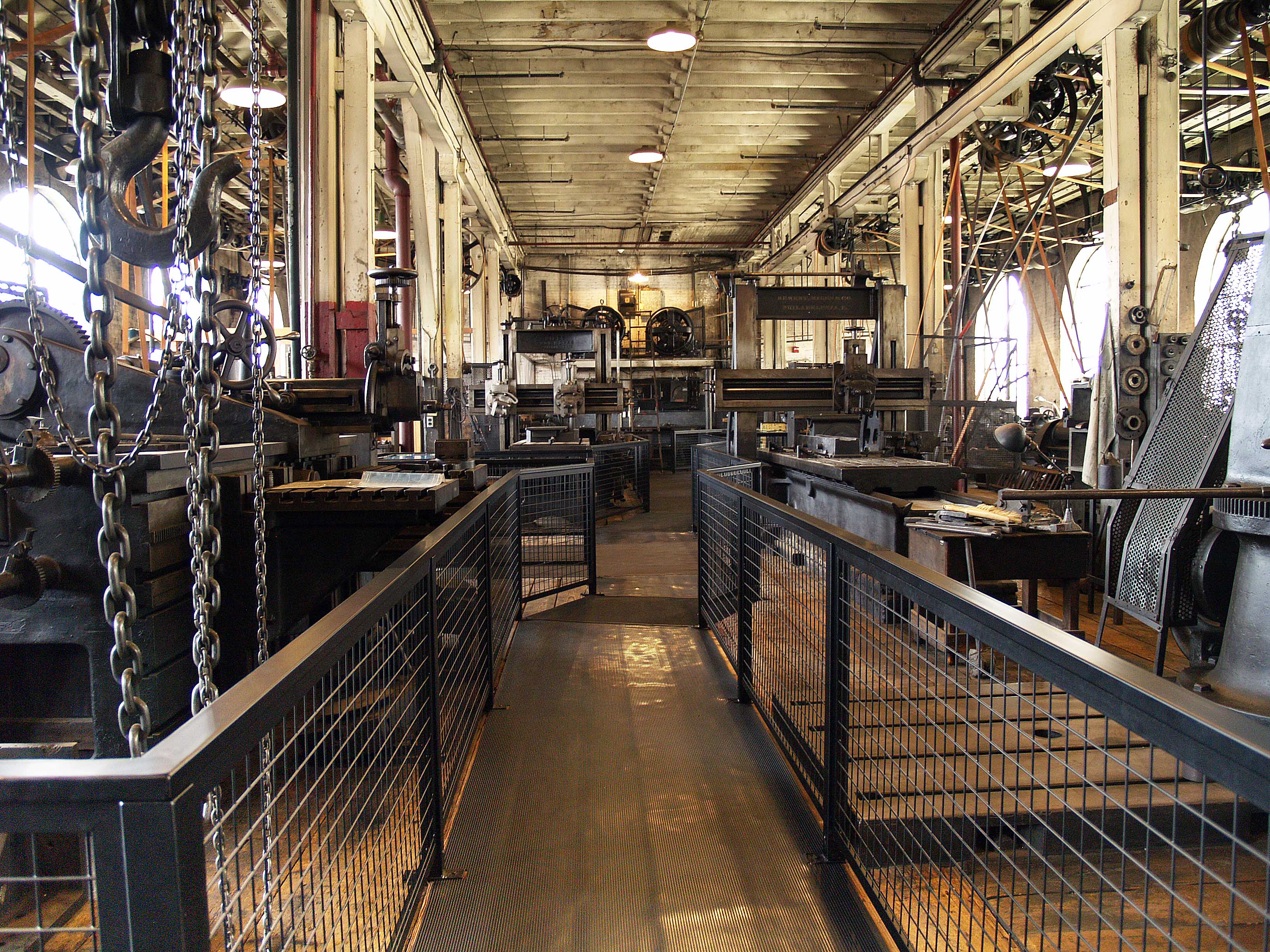 Large work space room with machines connected to belts and pullies