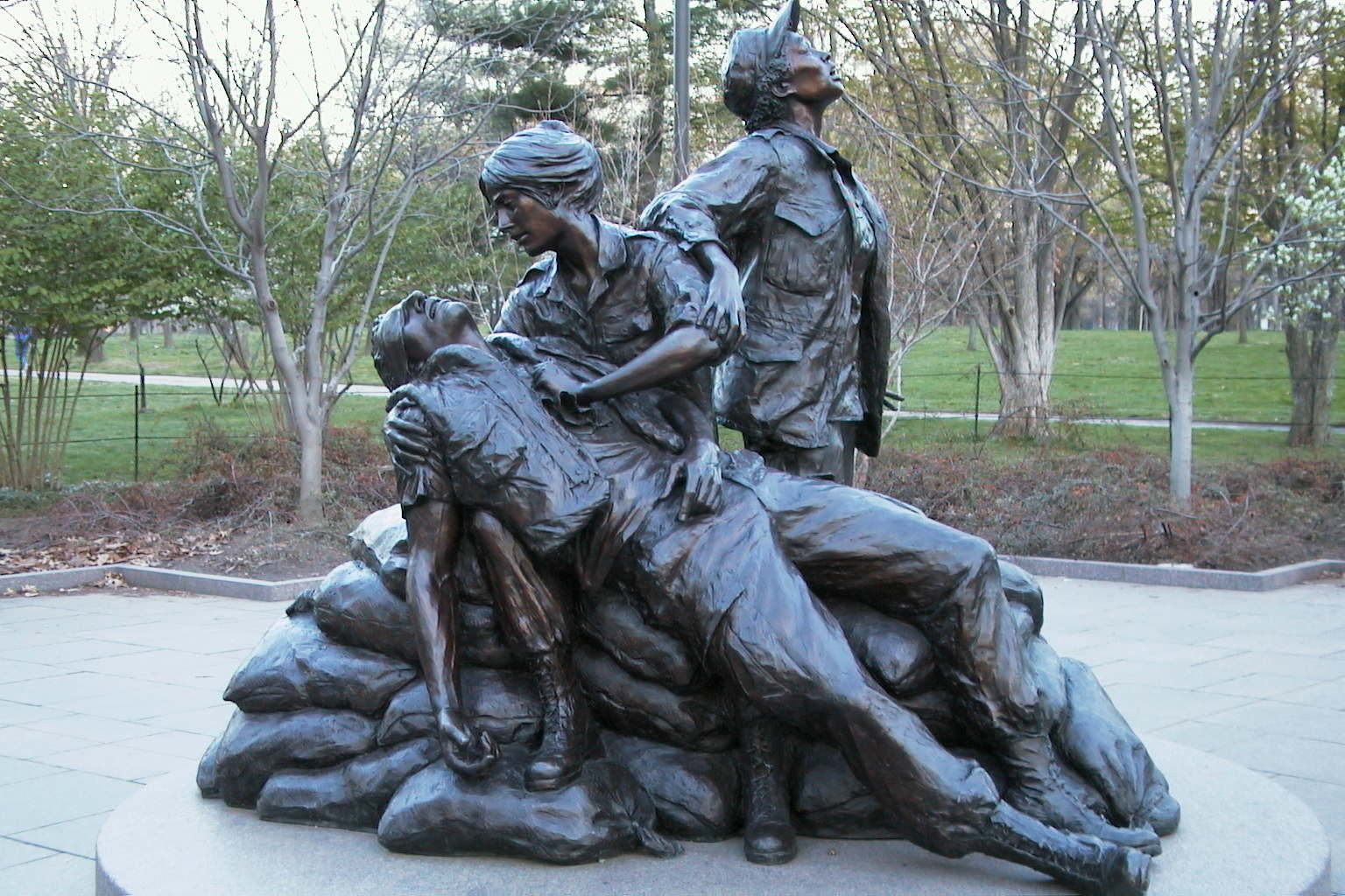 Bronze statue of three women with a wounded soldier.