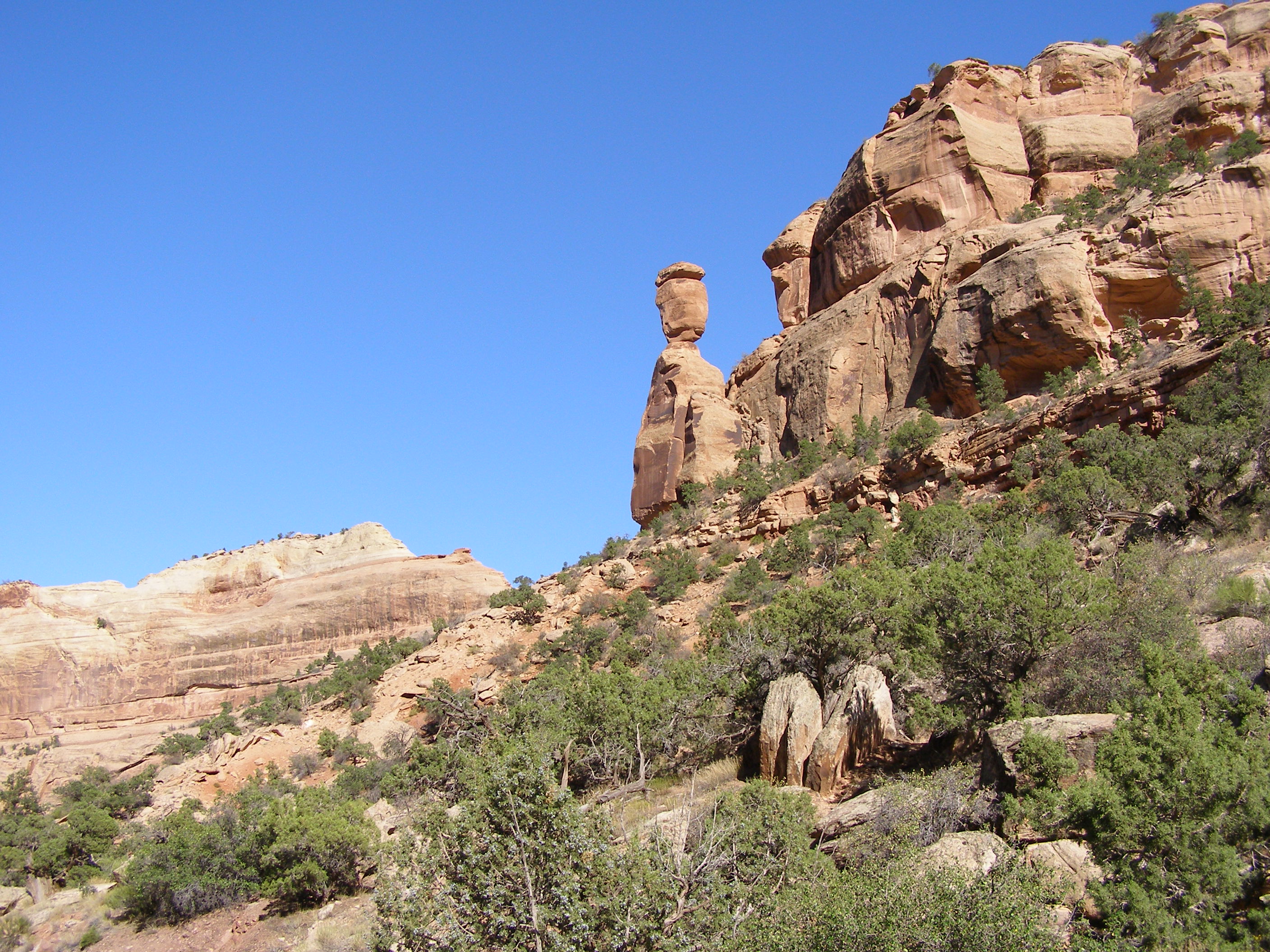 Rock spire with large boulder balancing on top.