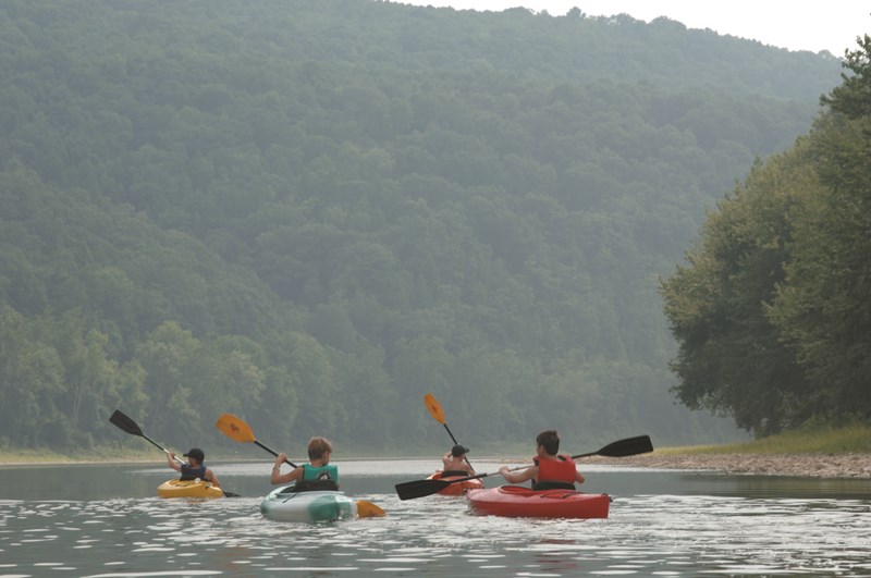 Kayak Kids Four youngsters paddle kayaks on calm waters of the Susquehanna River