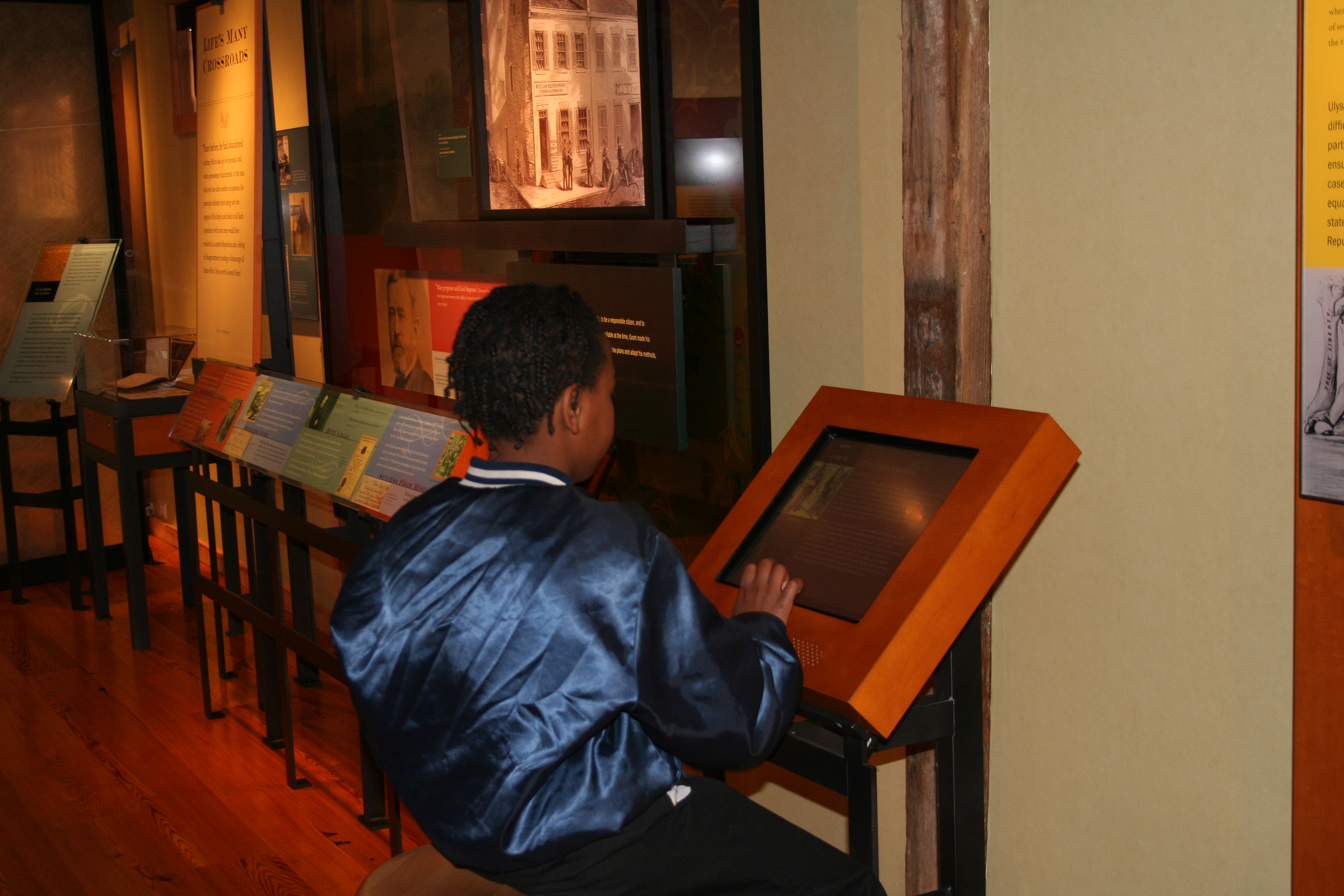 boy looking at touchscreen in museum