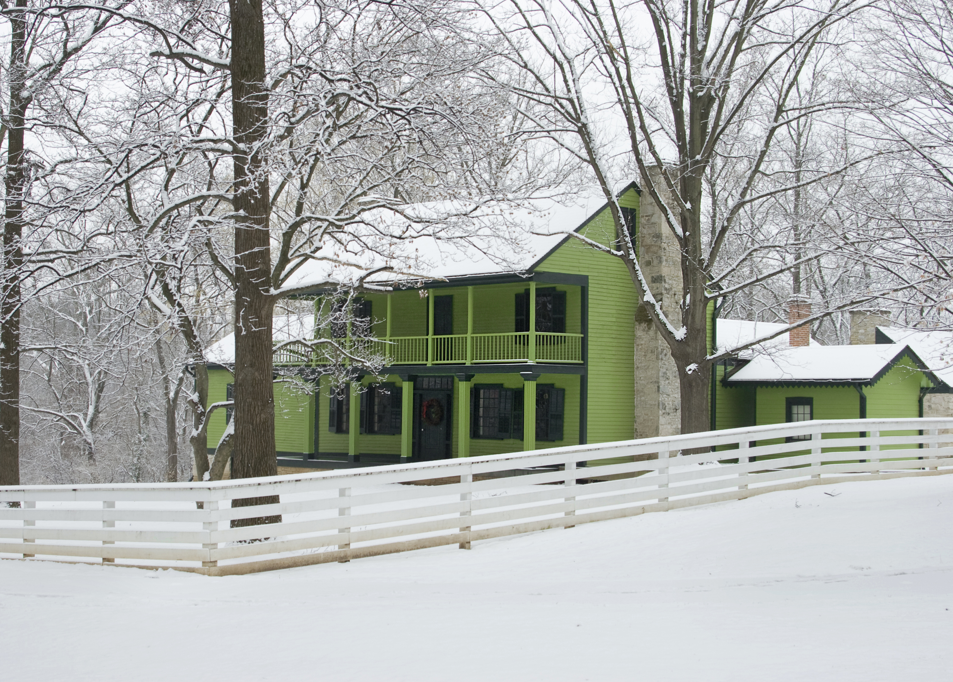 Historic green house with snow on ground