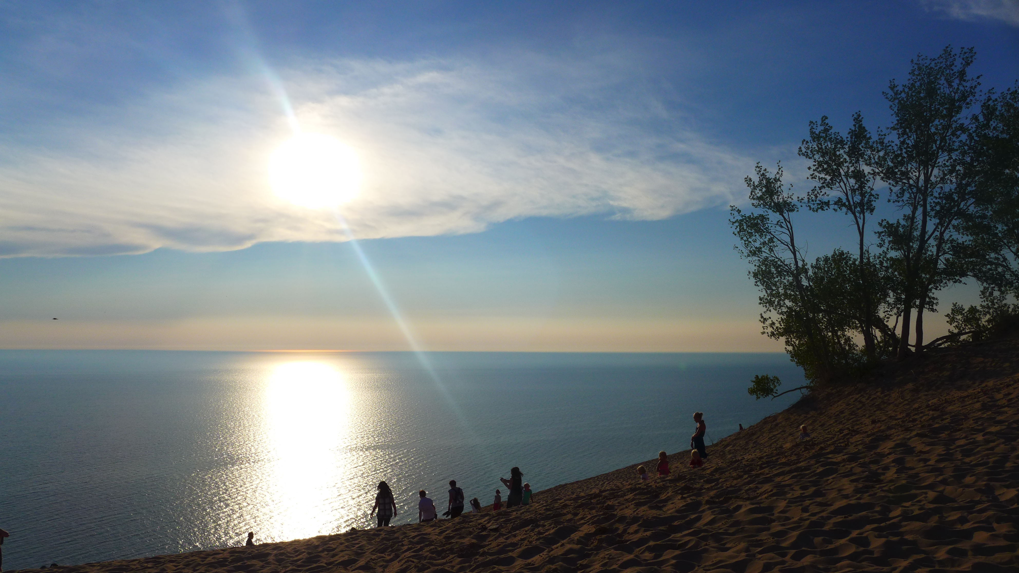 A bright sun begins to set into Lake Michigan