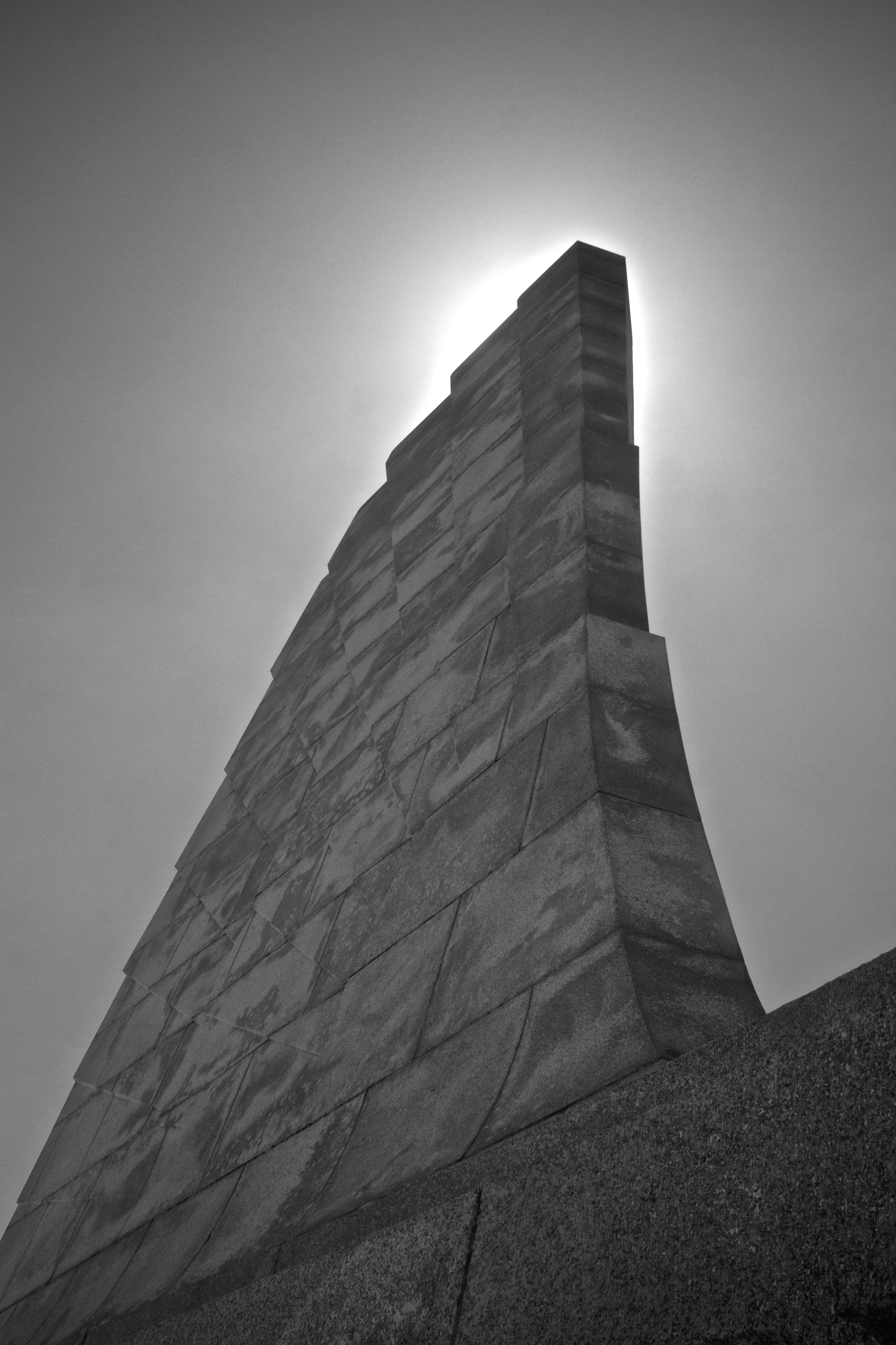 View straight up at the monument with the Sun directly behind the stonework.