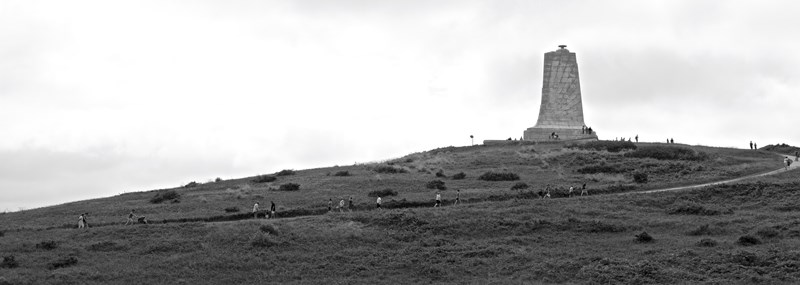 Journey to the Top Visitors moving along a sidewalk to the top of the hill where the monument stands.