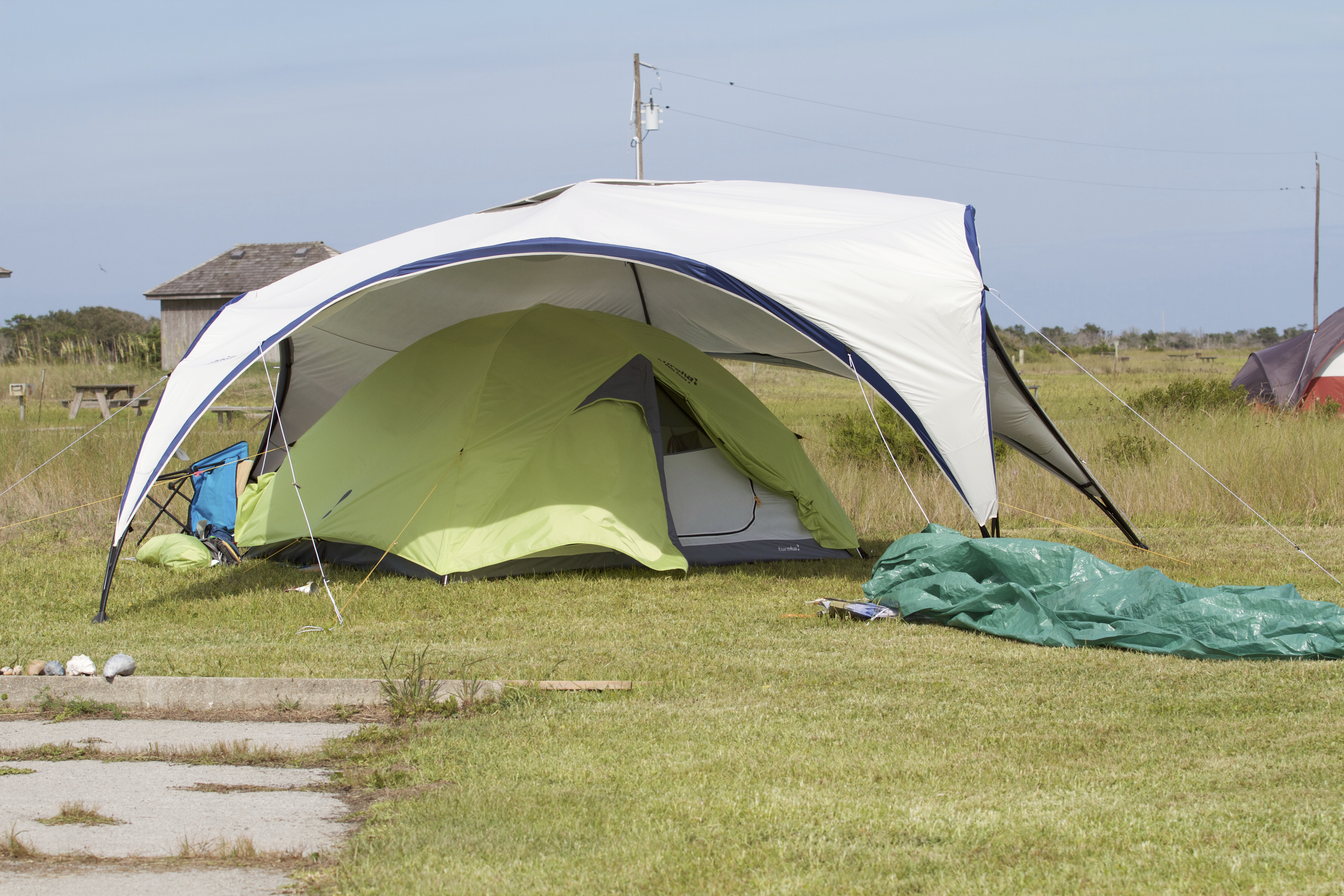 Camp site with a tent and additional shade canopy.