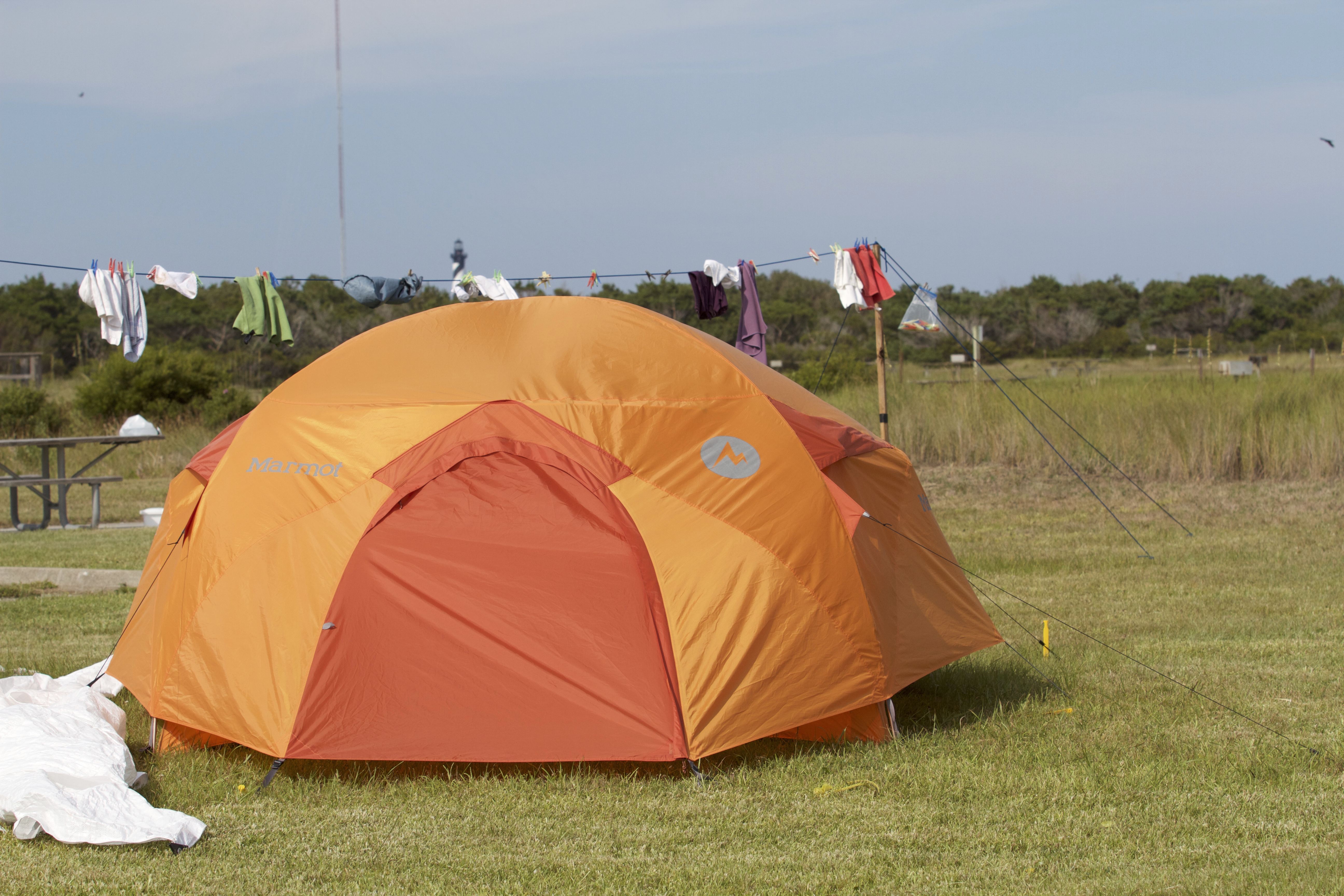 Orange tent set up at a grassy camp site at Cape Point Campground.