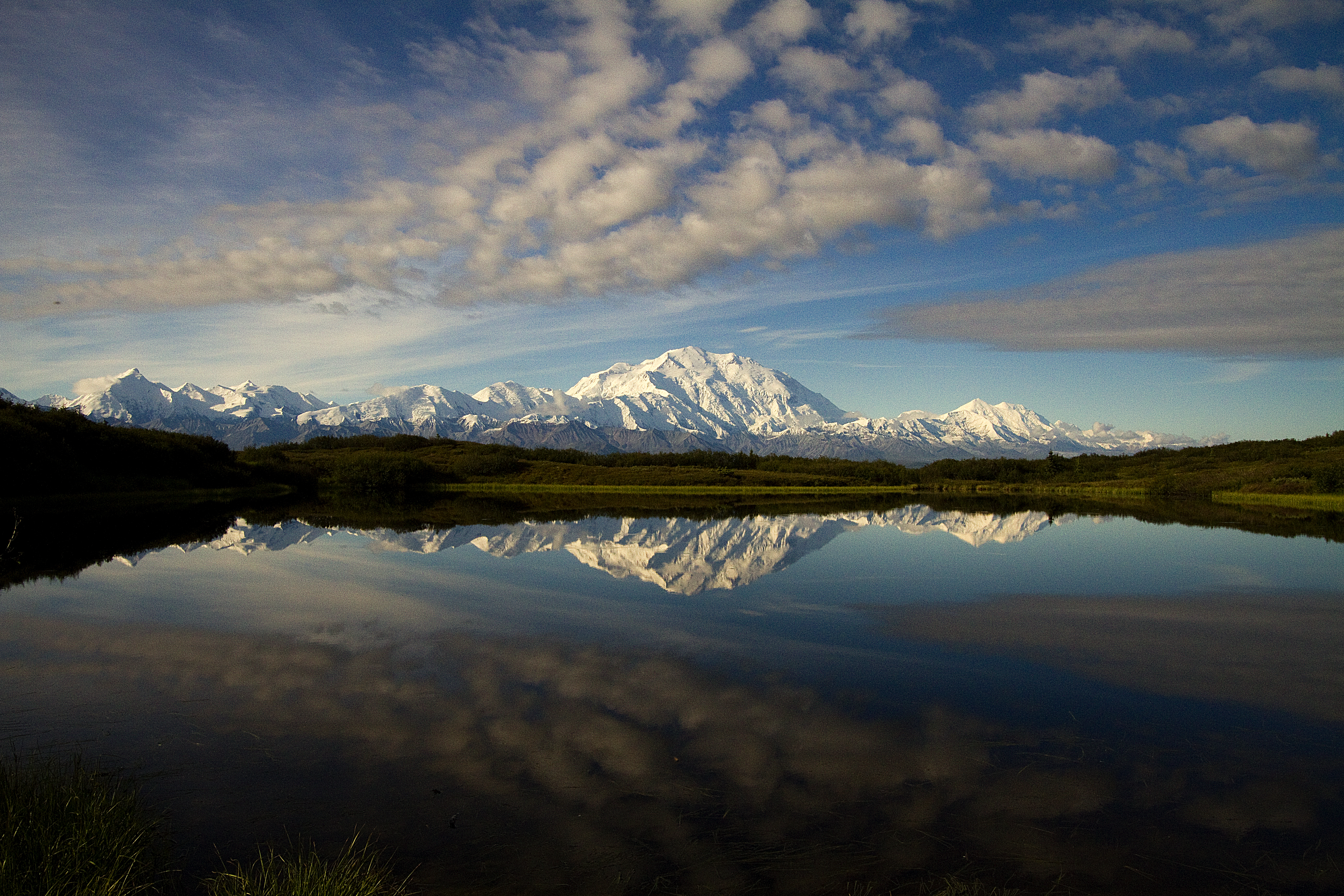 snowy mountains reflected in a pond