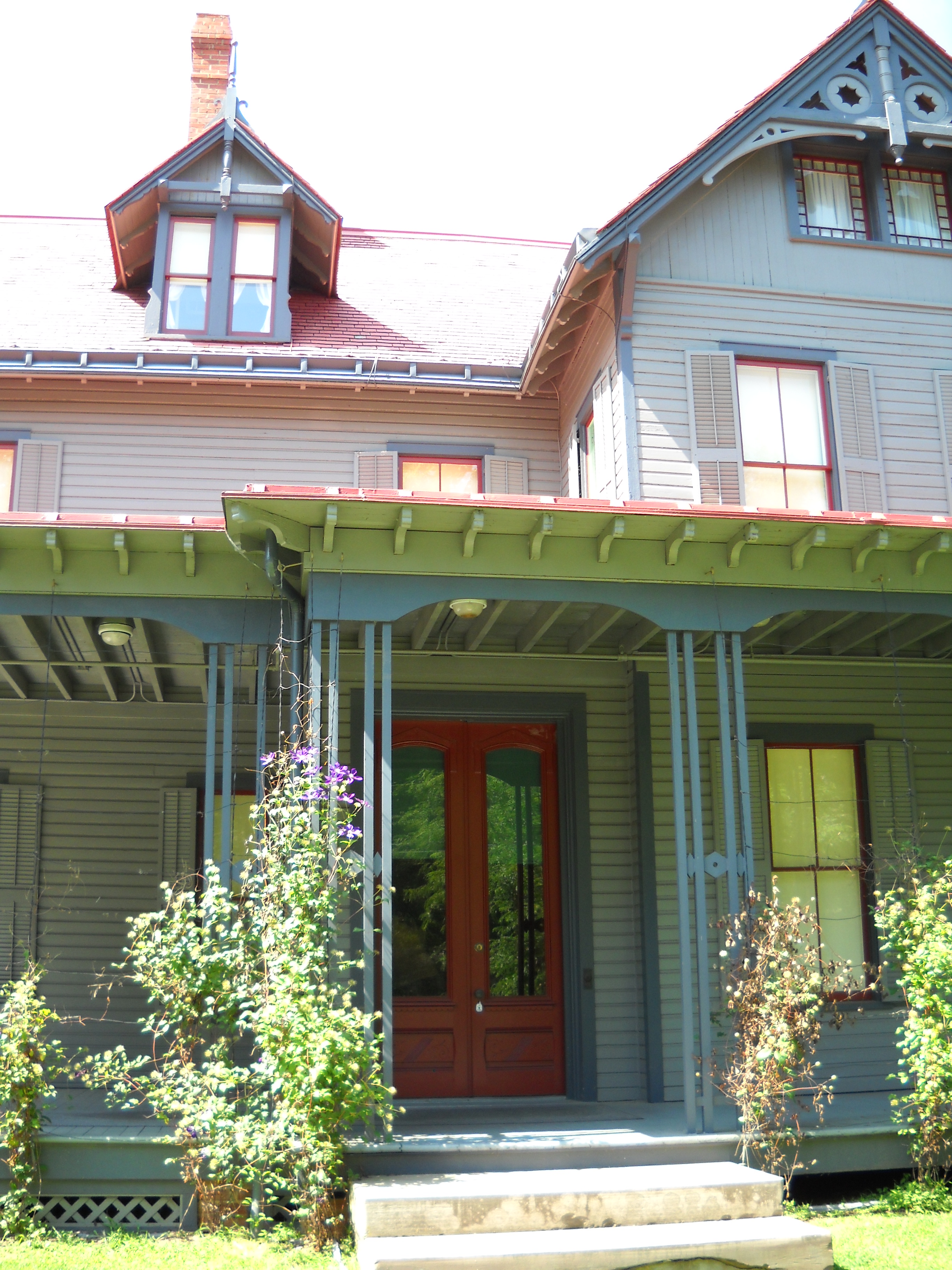 Front porch of Garfield home showing red front door