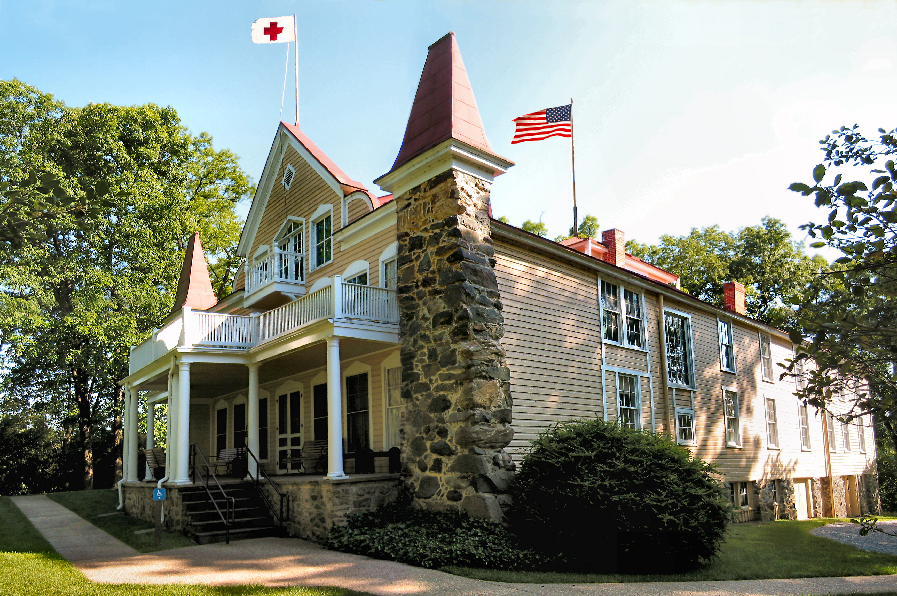 side view of Clara Barton's house with Red Cross flag and American Flag.