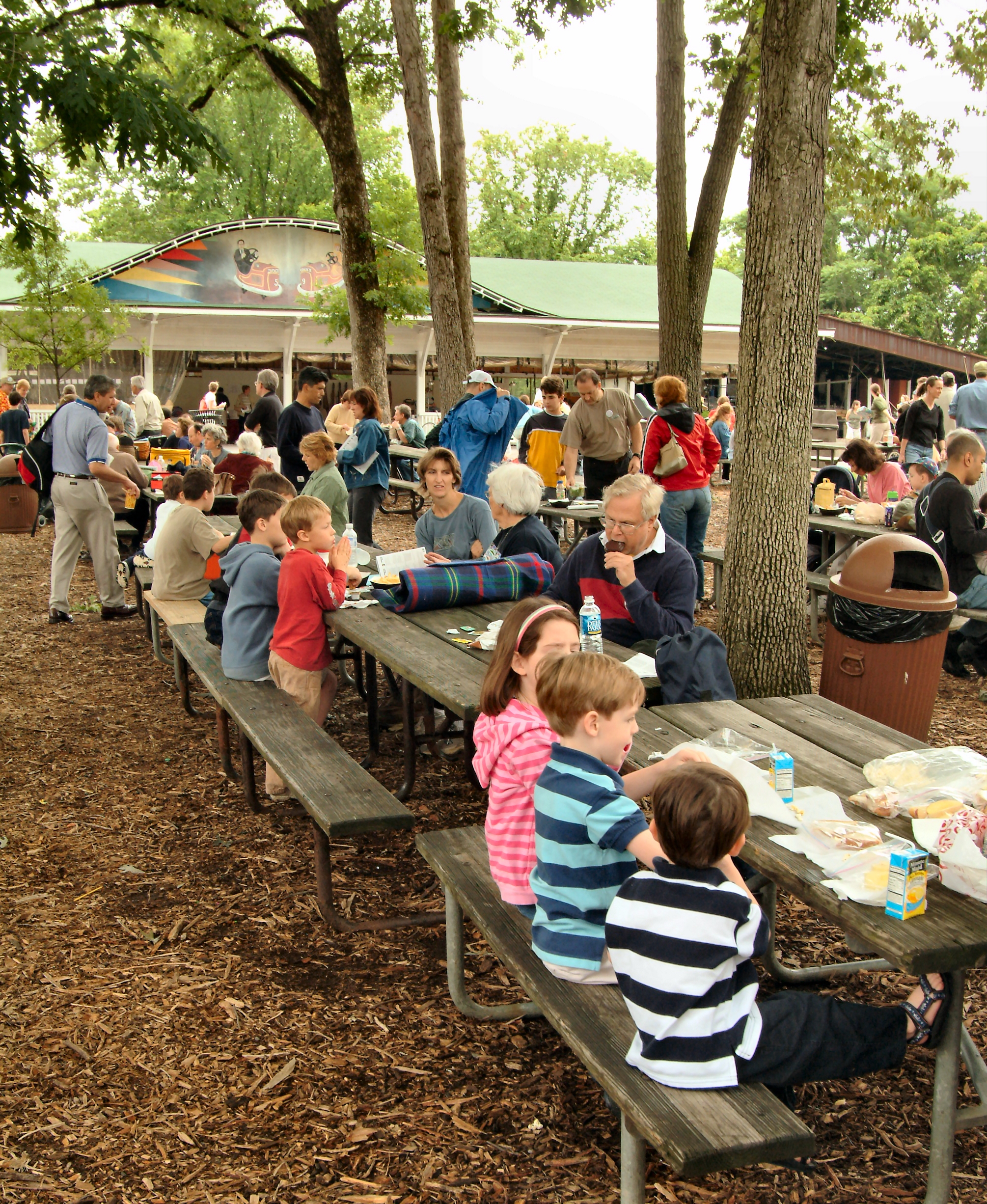 people gathered at picnic tables enjoying a lunch in Glen Echo Park