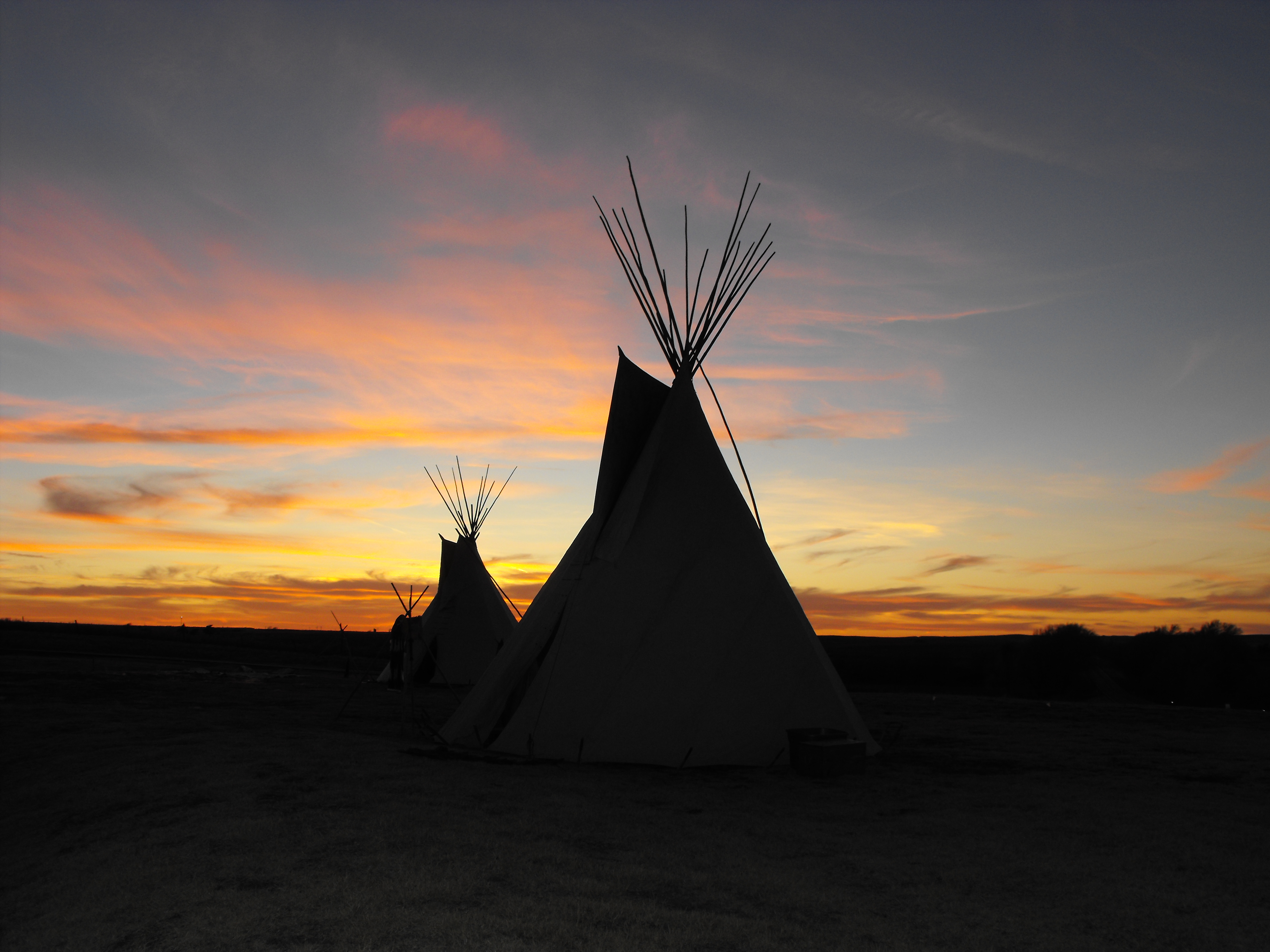 Cheyenne tipis backlite by sunset