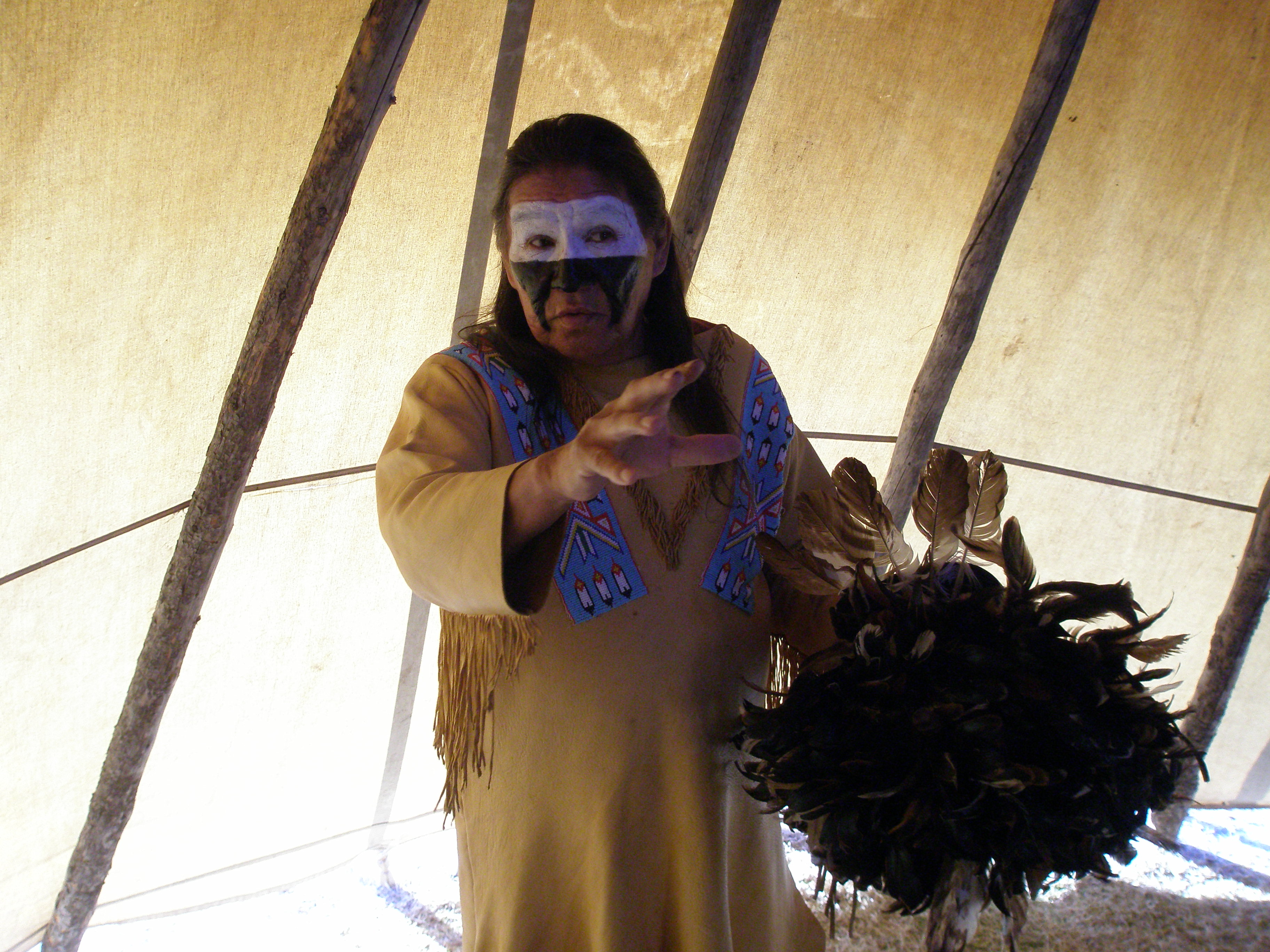A Cheyenne Dog Soldier tells stories inside his tipi