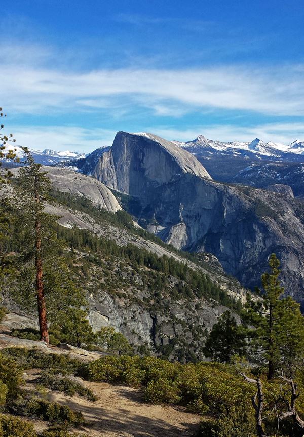 The granite dome of Half Dome with traces of snow on its face.