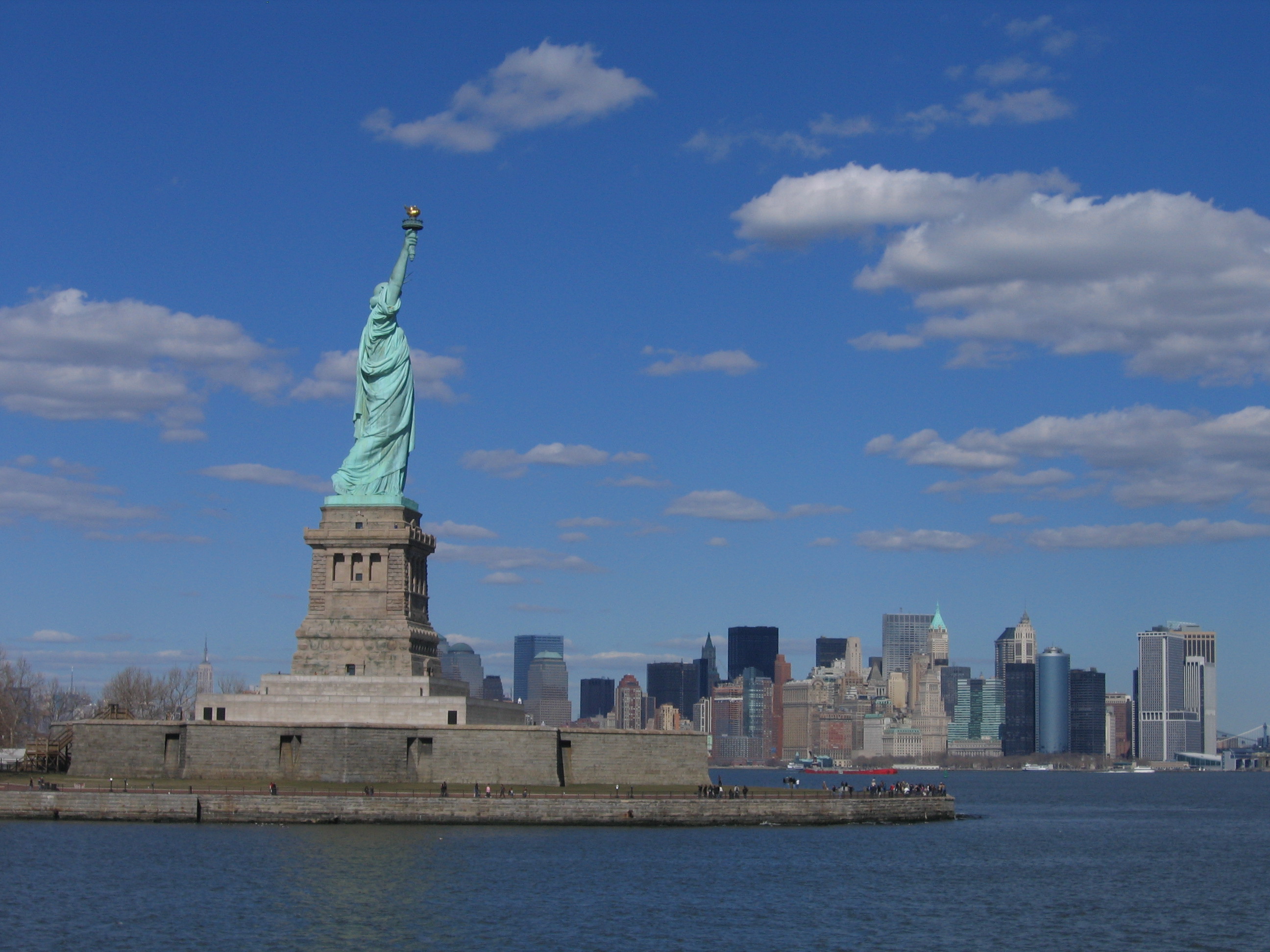 The Statue of Liberty in front of the New York City skyline.