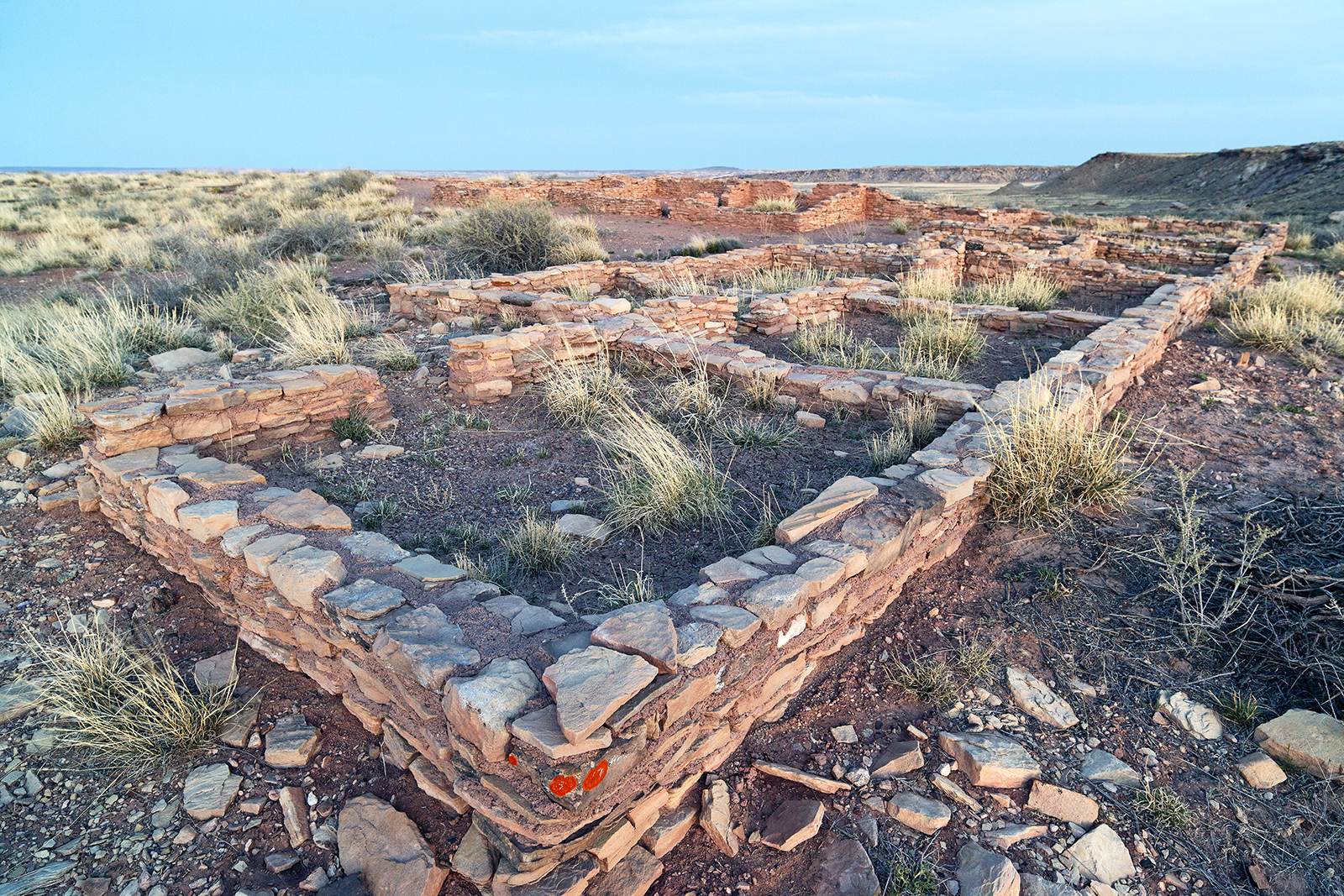 Masonry wall foundations are all that are left of a hundred room pueblo