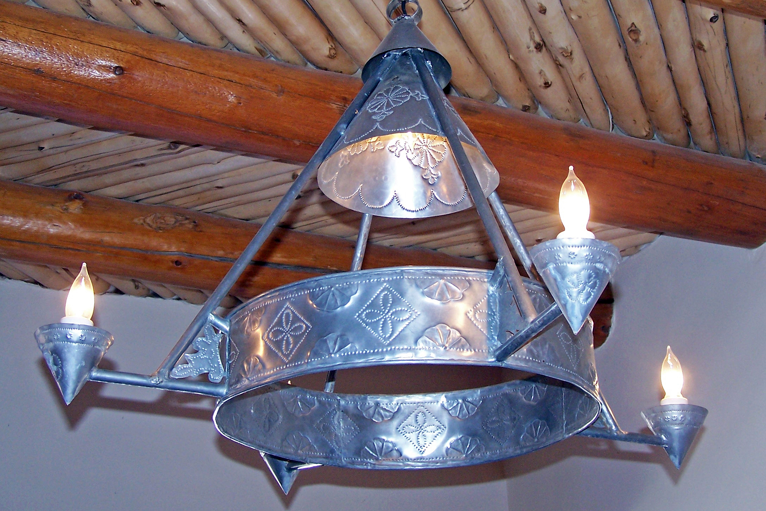 handmade Spanish colonial style punched tin light fixtures were made by the CCC