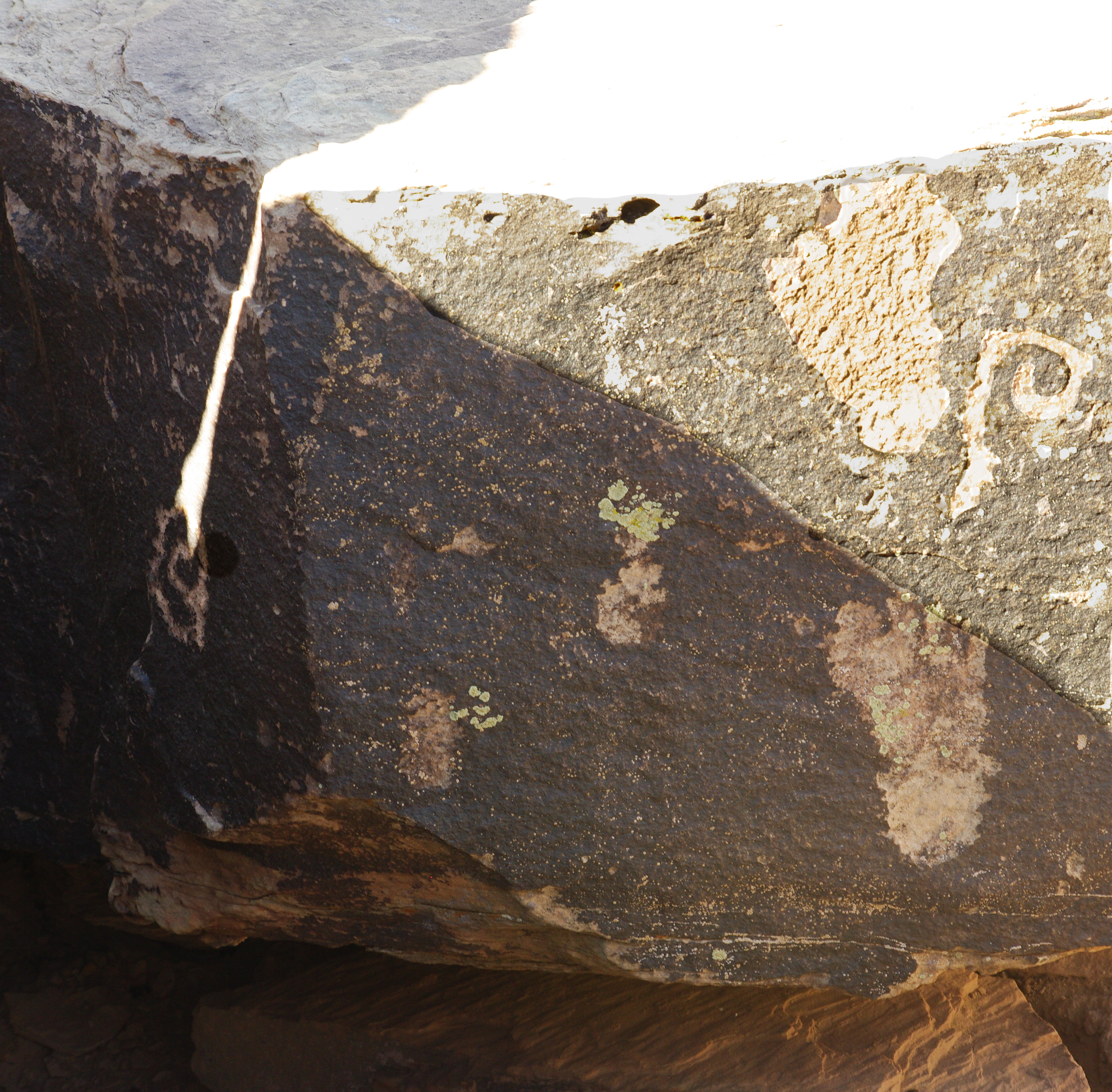 A beam of light touches a petroglyph at Puerco Pueblo on the summer solstice