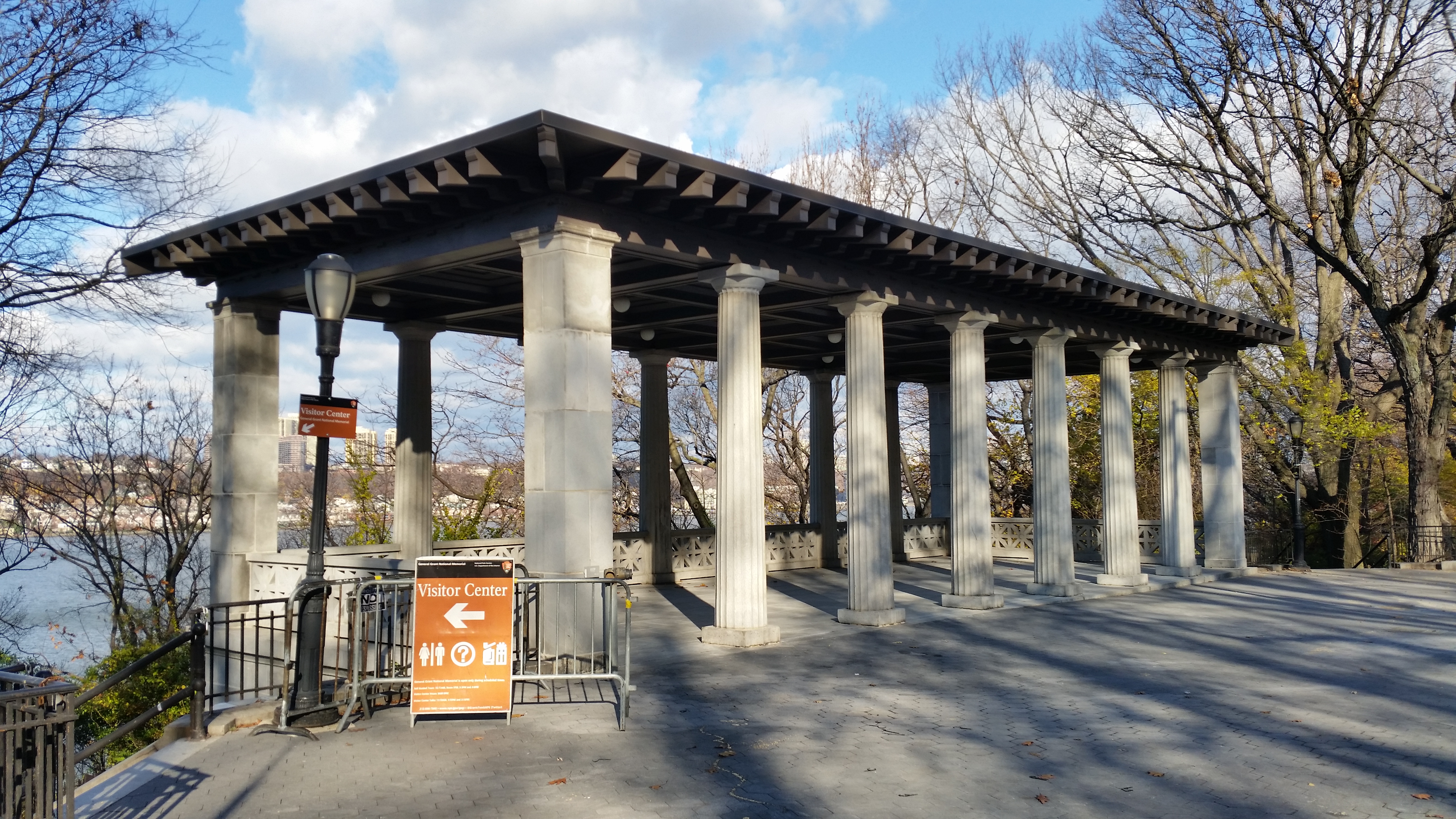 A neoclassic pavilion sits on the hillside, surrounded by trees with the Hudson River below.