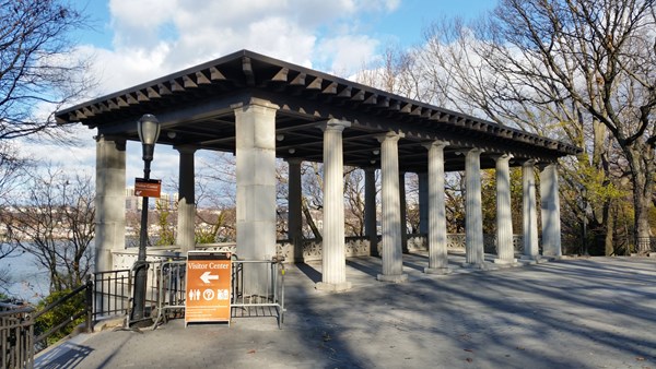 A neoclassic pavilion sits on the hillside, surrounded by trees with the Hudson River below.