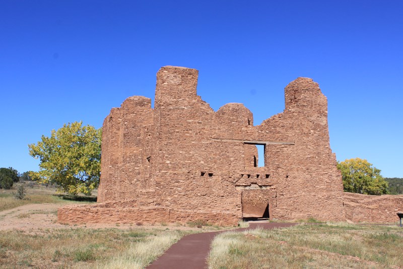 Quarai Mission Stone walls of a roofless building rise into a bright blue sky.