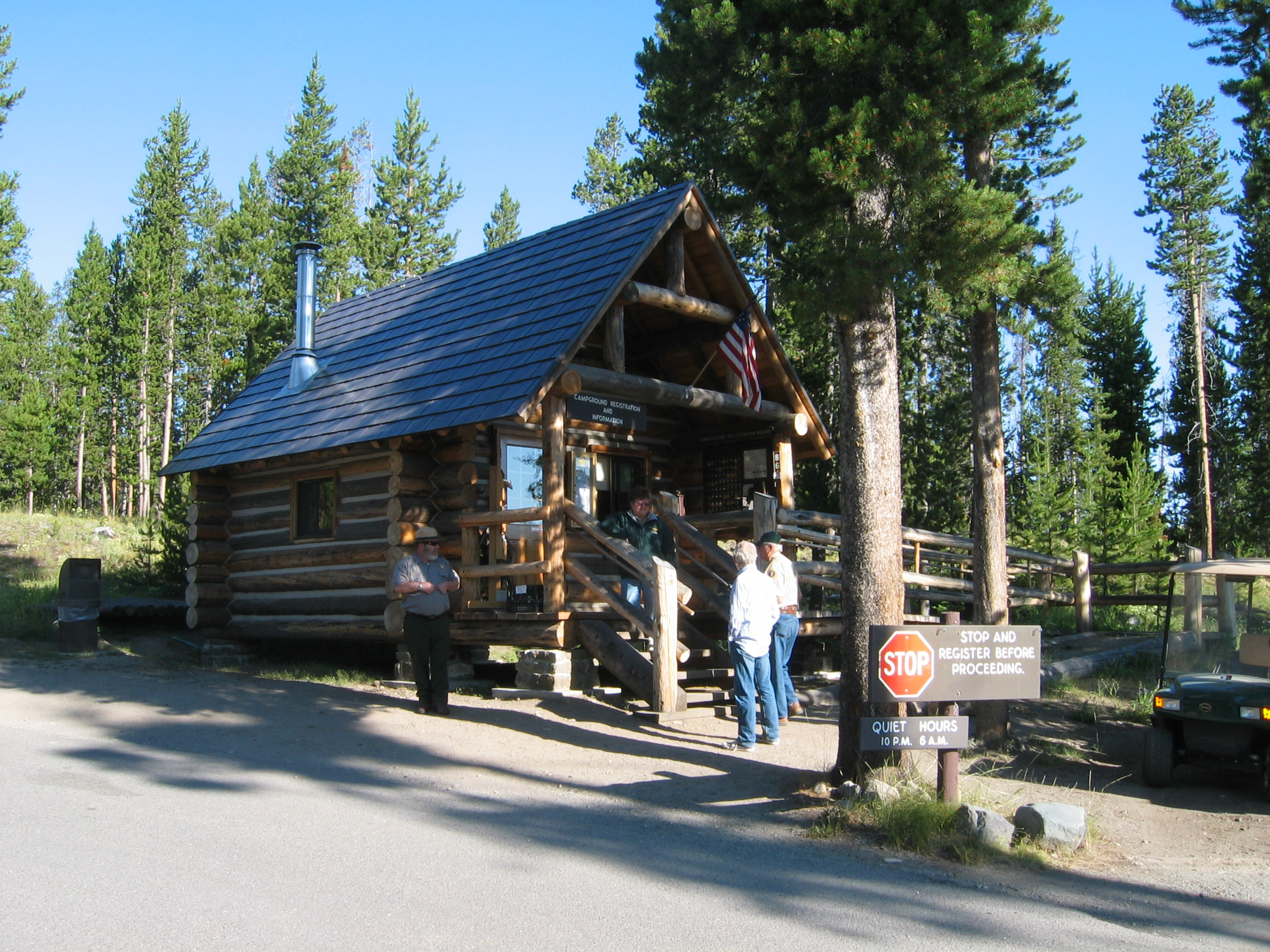 People standing in front of log building