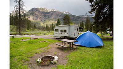 Tent and camper at campsite.