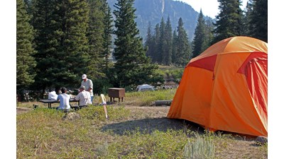 Visitors and tent at campsite.
