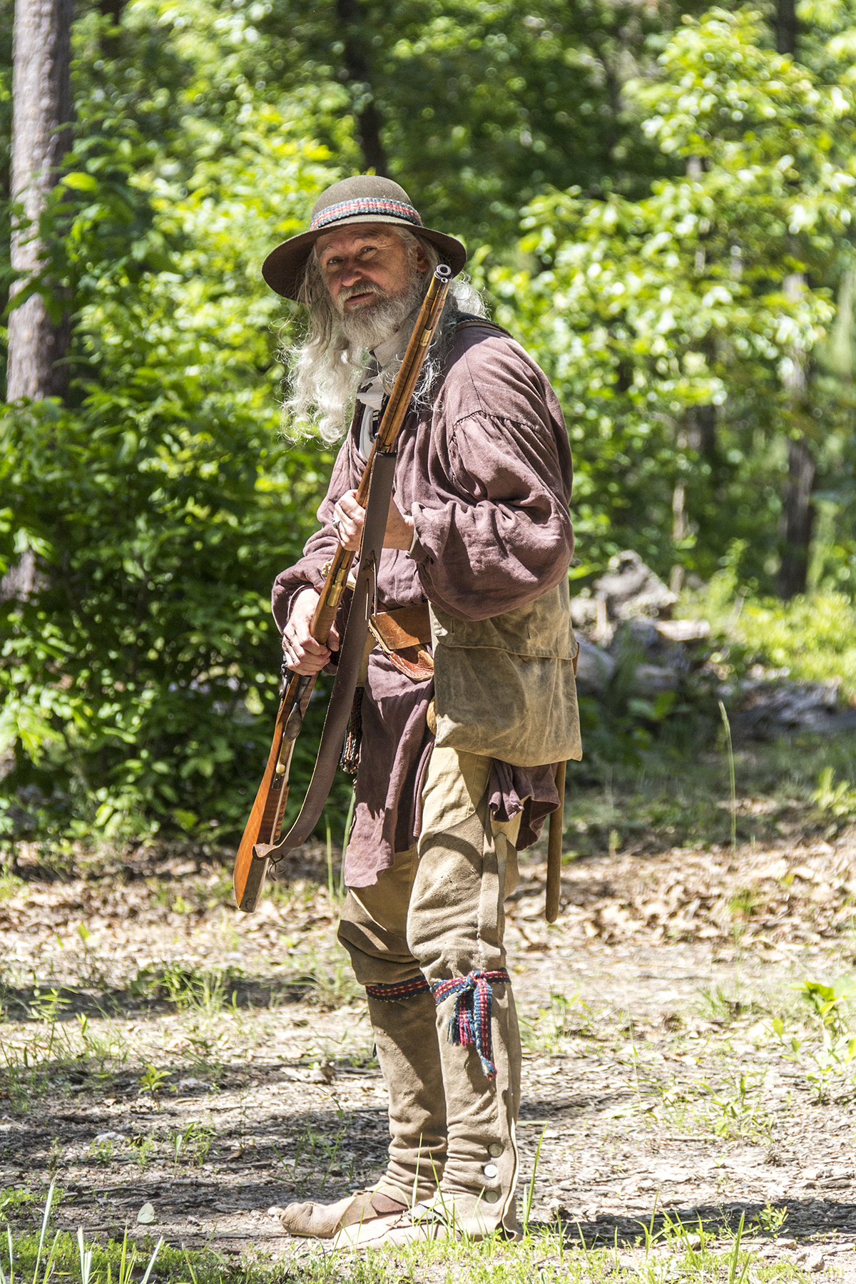 A patriot rifleman stands ready to fire his weapon.