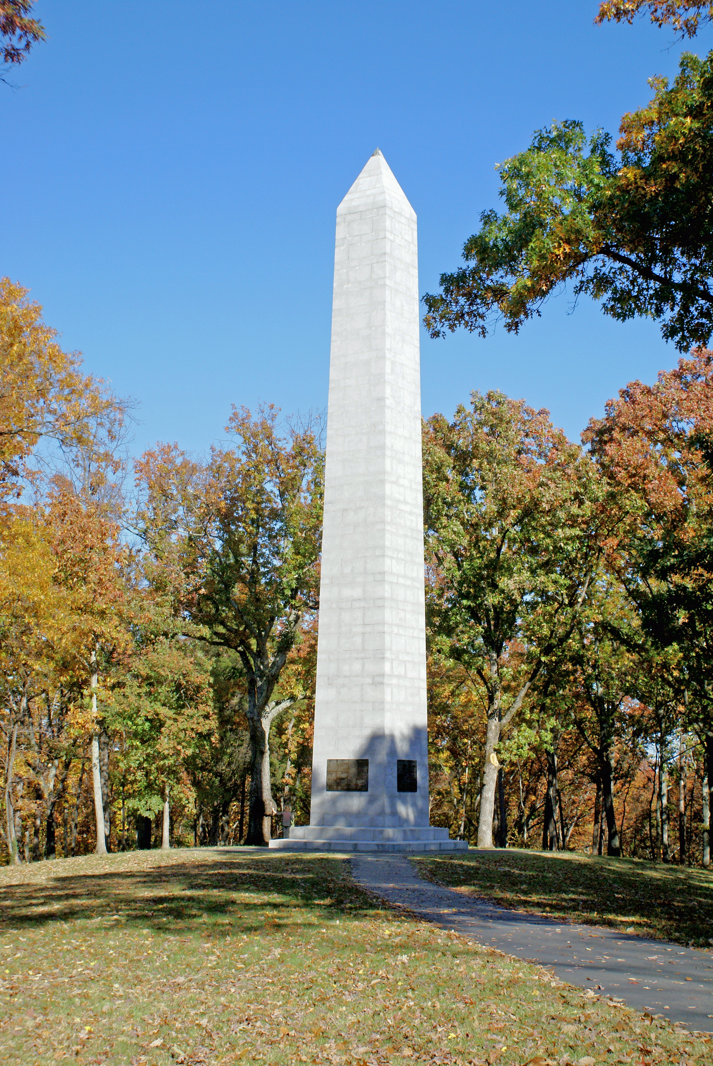 The US Monument is surrounded by trees that are turning orange and yellow.