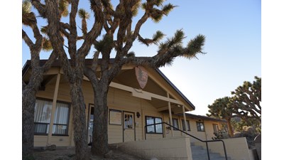 A small parking lot with cars and a building.