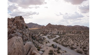 Looking down on Indian Cove Campground with the road, a vault toilet and campsites.