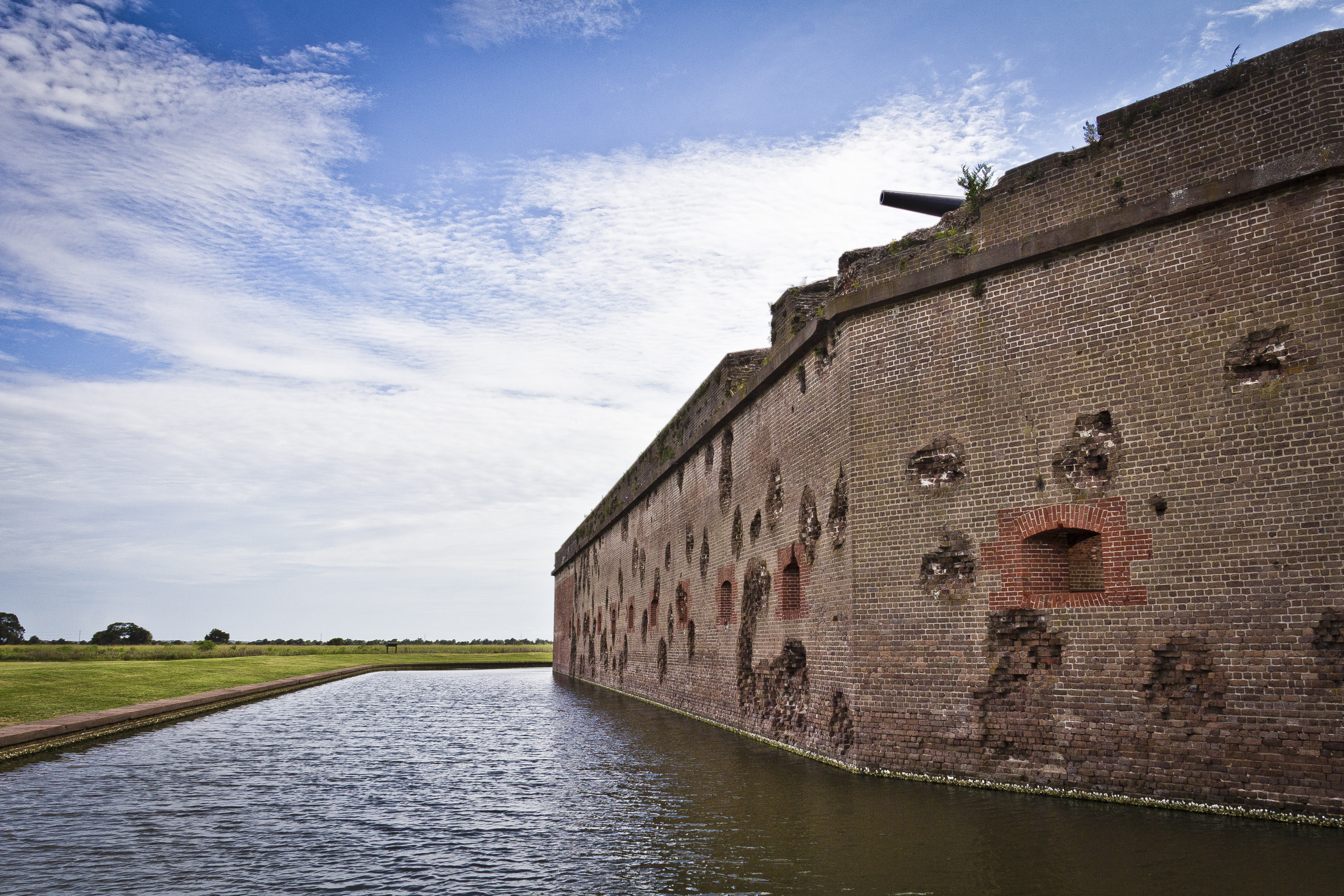 The red masonry walls of Fort Pulaski still show battle damage over 150 years later.