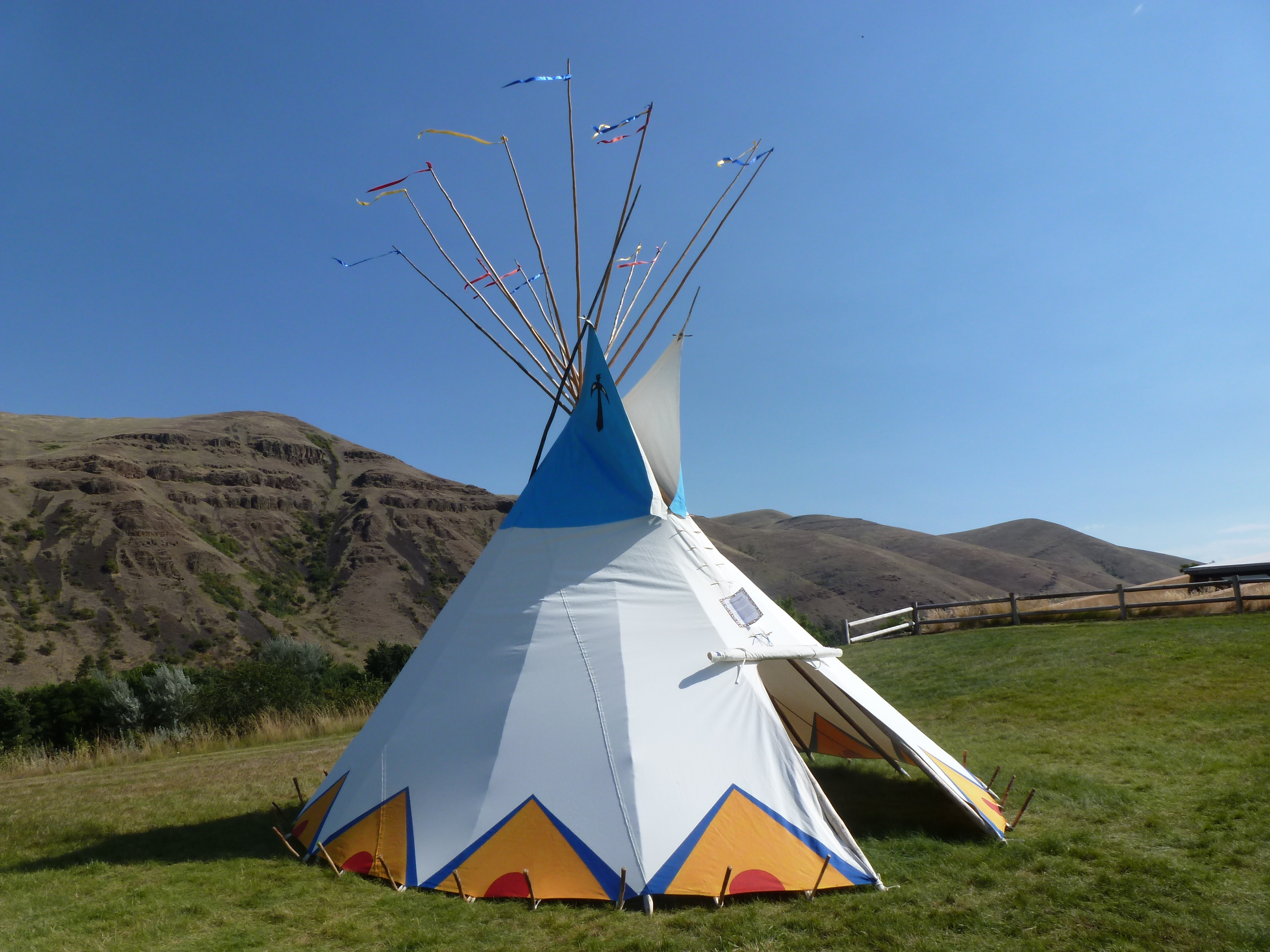 Colorful painted tipi on green lawn