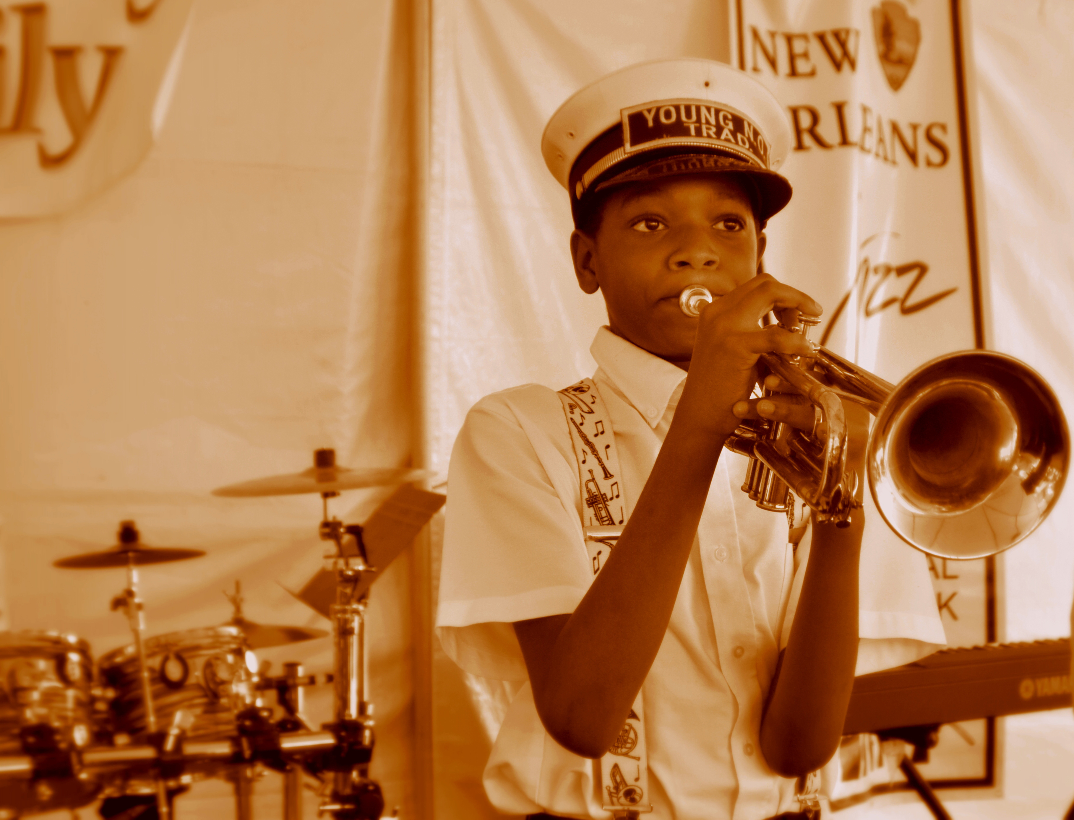 A young brass band musician plays a trumpet