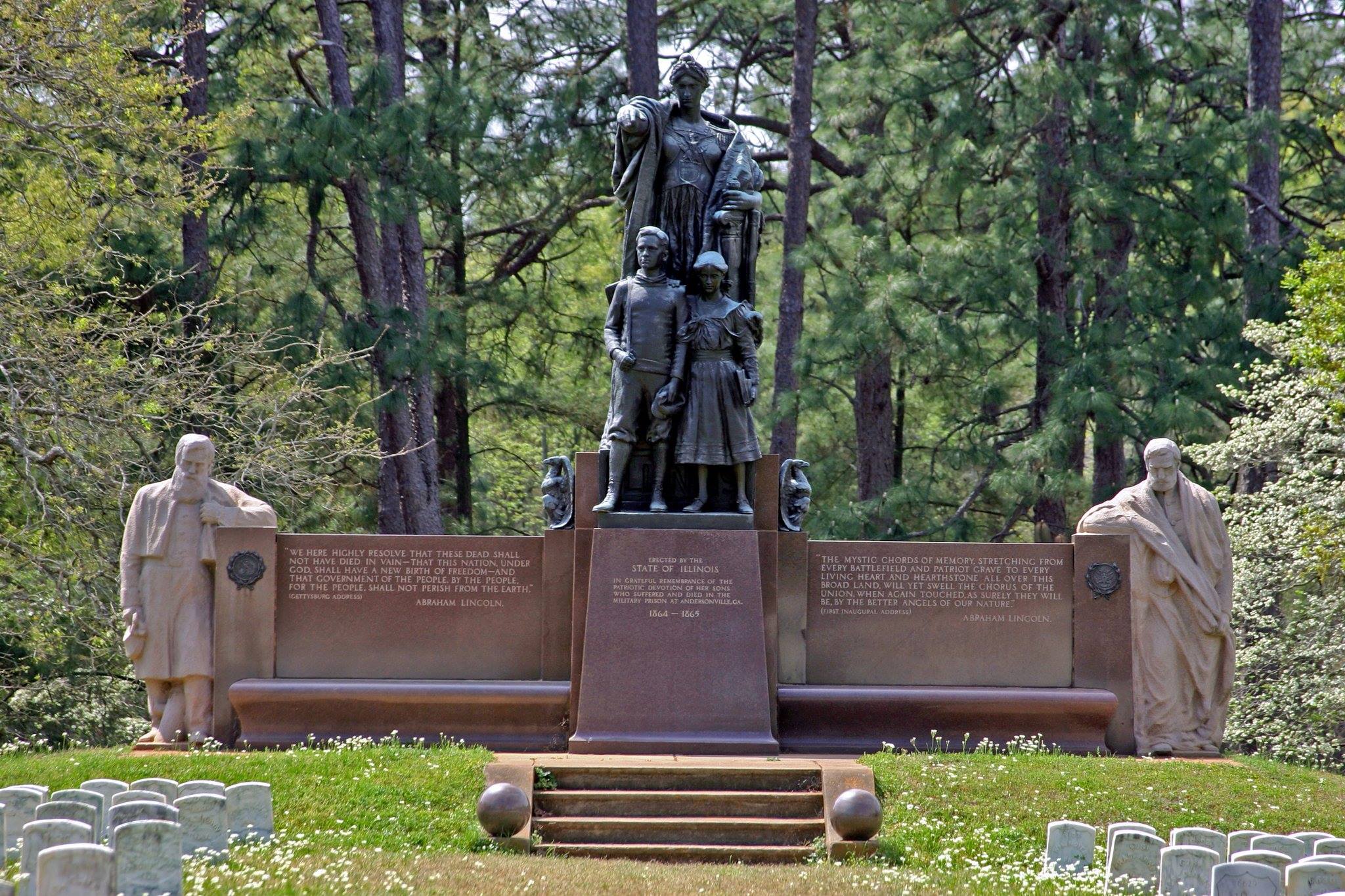 A large stone monument with 2 Civil War soldiers, a female figure, and 2 children.