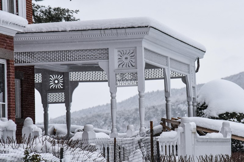 Mansion in Winter white awing of red brick building covered in snow