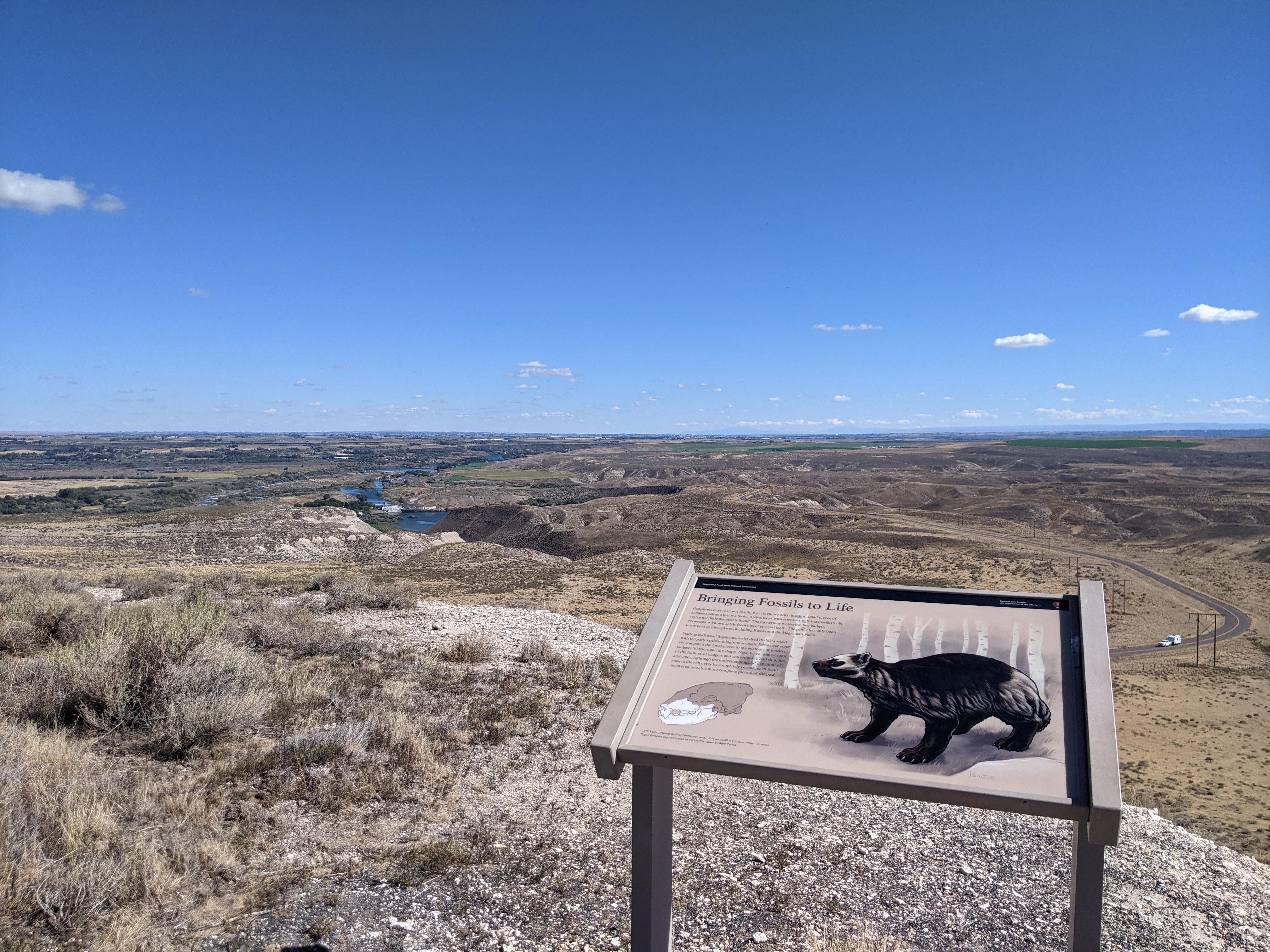 An educational exhibit along a trail overlooks panoramic views of the Hagerman Valley.