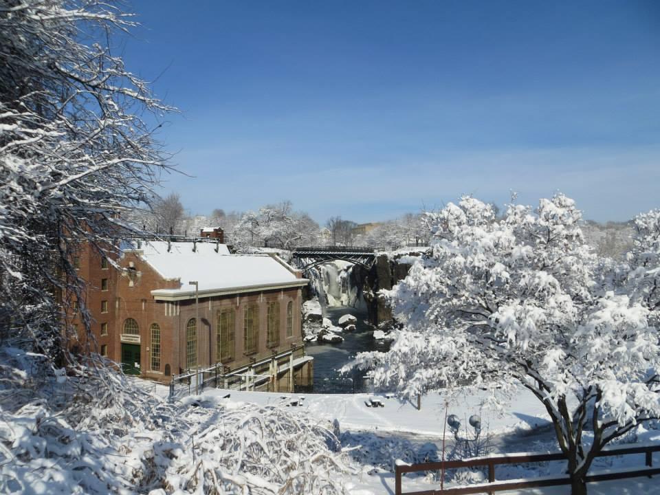 snow covered hydro plant and waterfall