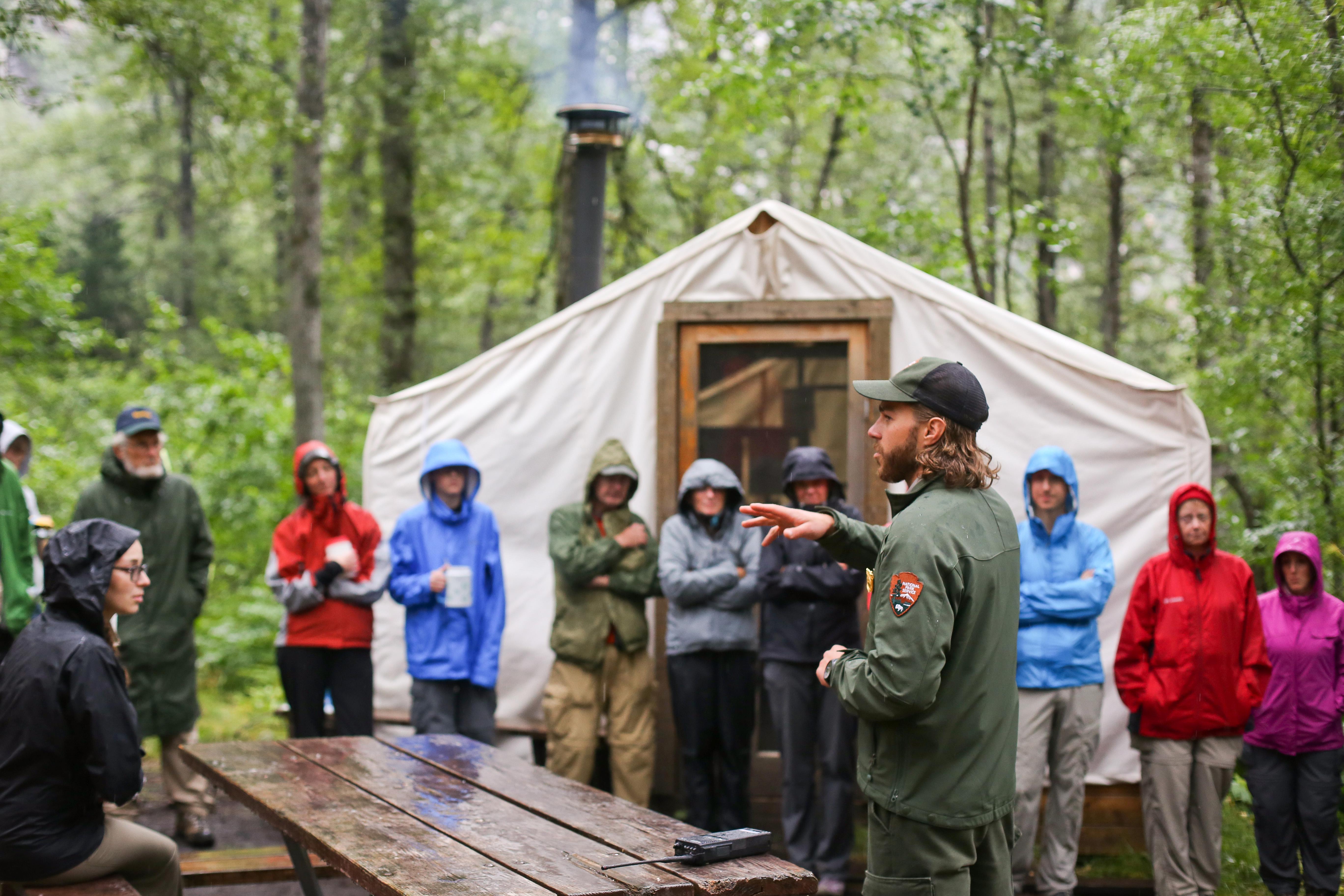 Ranger talks to a group of hikers in the rain