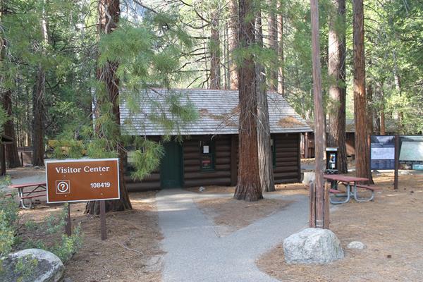 The Cedar Grove Visitor Center is a log cabin nestled among tall pines.